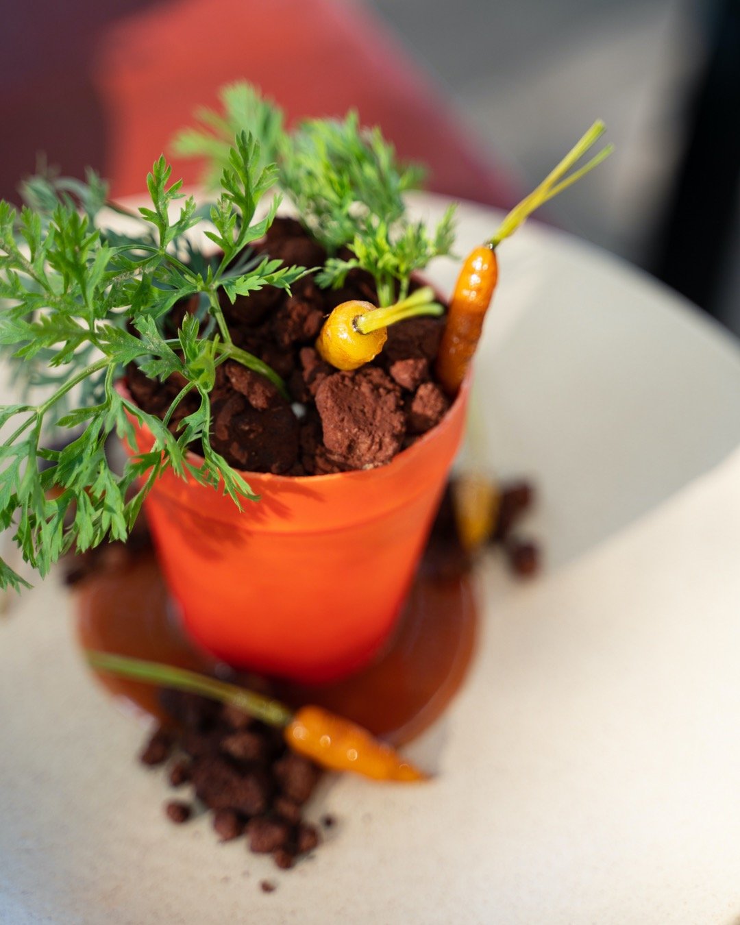 a dessert of a potted carrot cake plant that looks real by Paola Marocchi