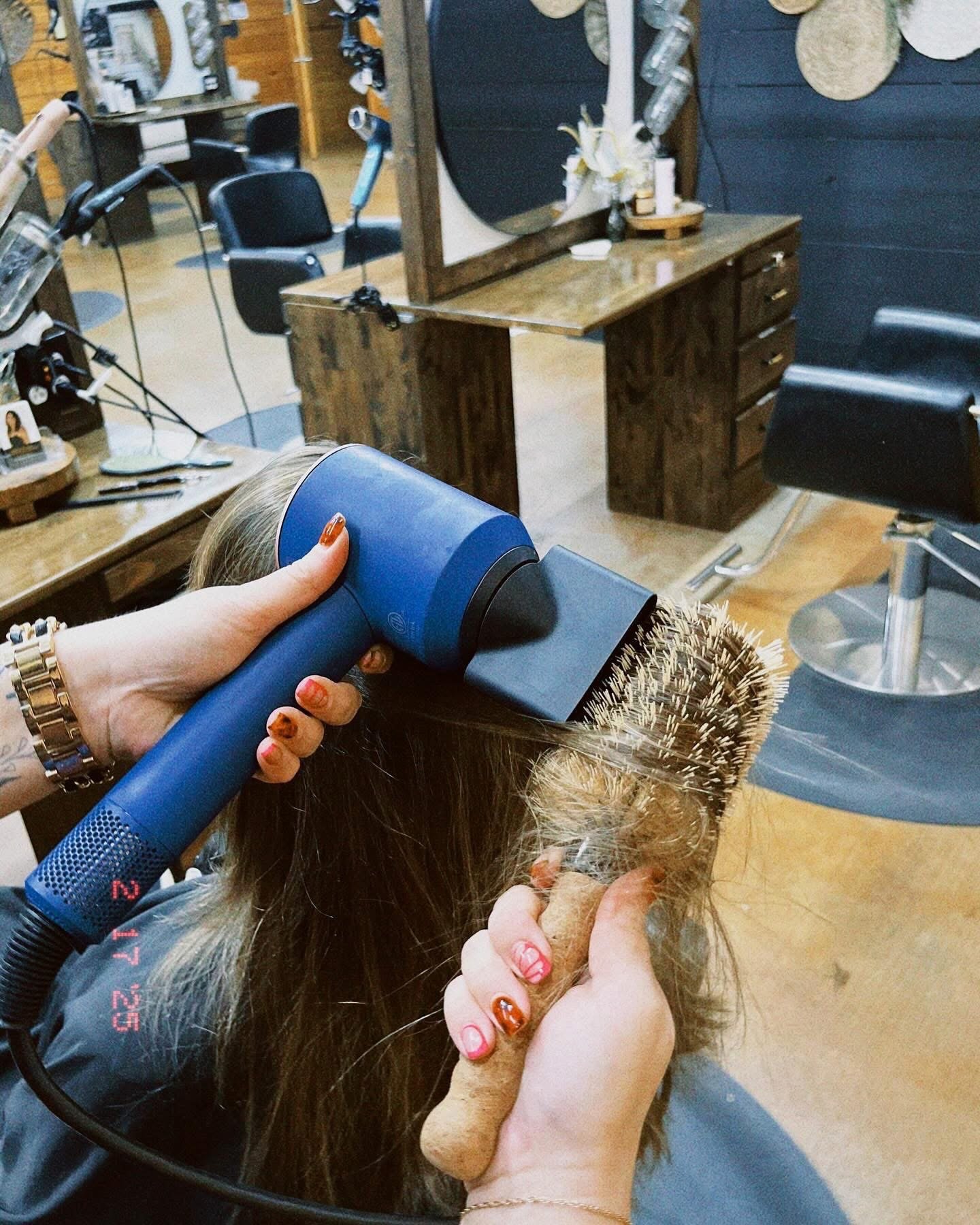 blow drying with Dyson dryer at Meraki and Co salon and spa greer sc 