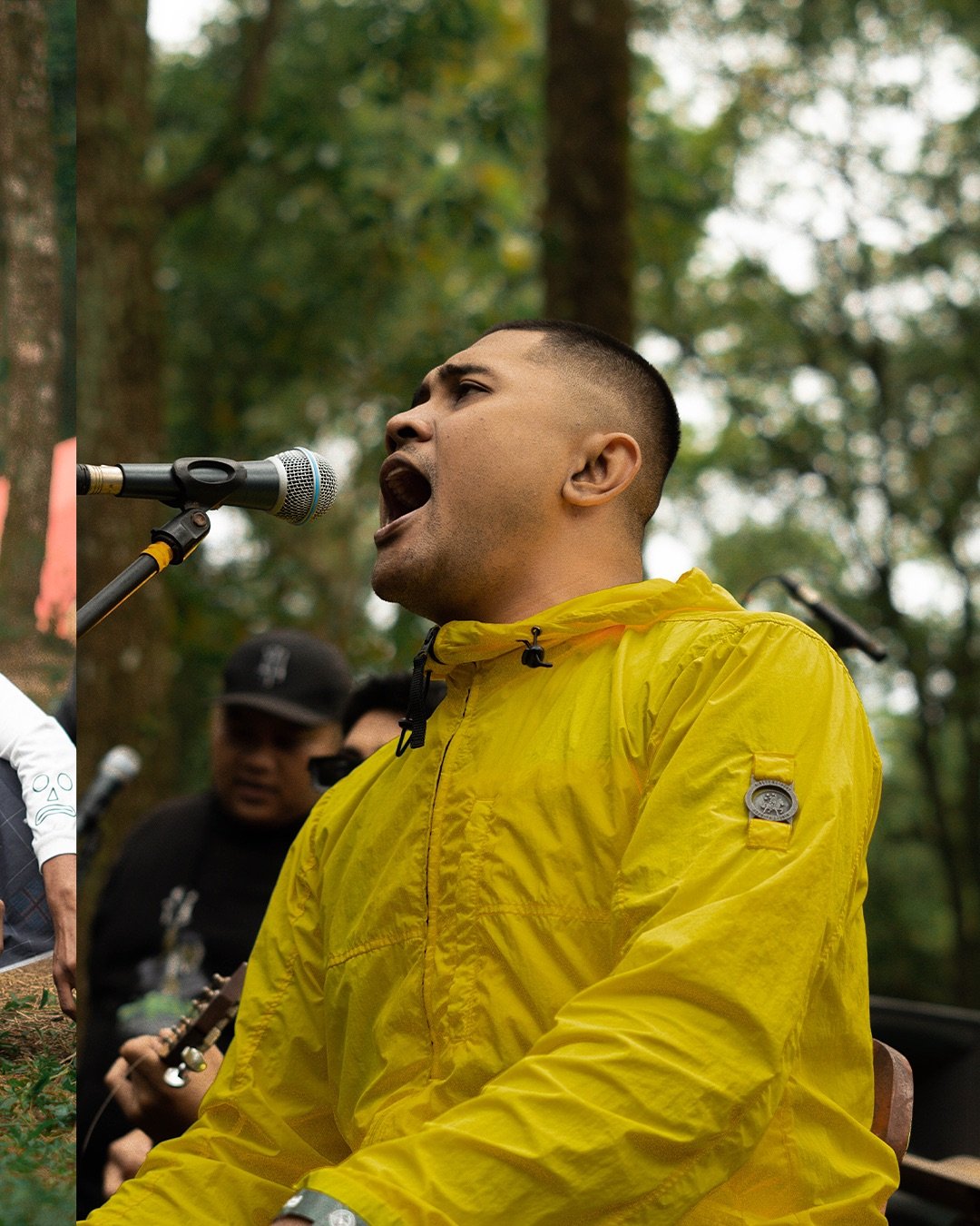 a man in a yellow jacket singing into a microphone