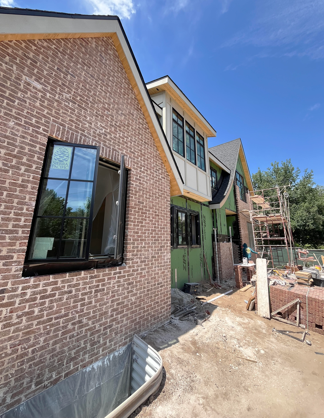 a brick building with a green door and a window