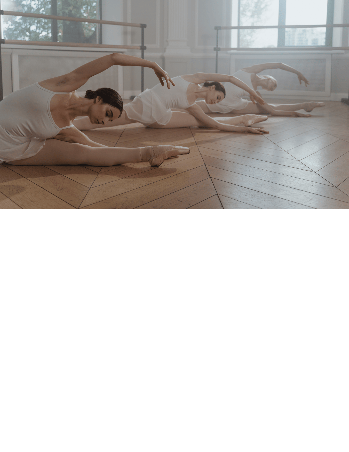 a group of people in white dresses are doing a yoga pose