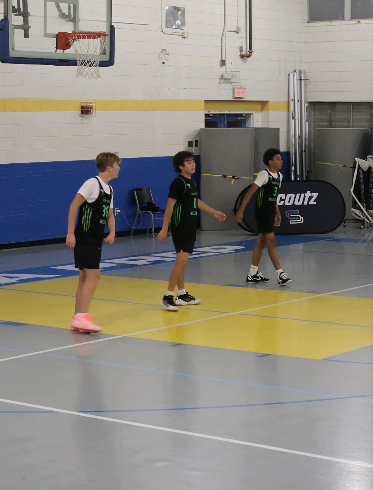 Wildcats playing basketball in a gym
