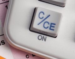 a calculator and pencils on a desk