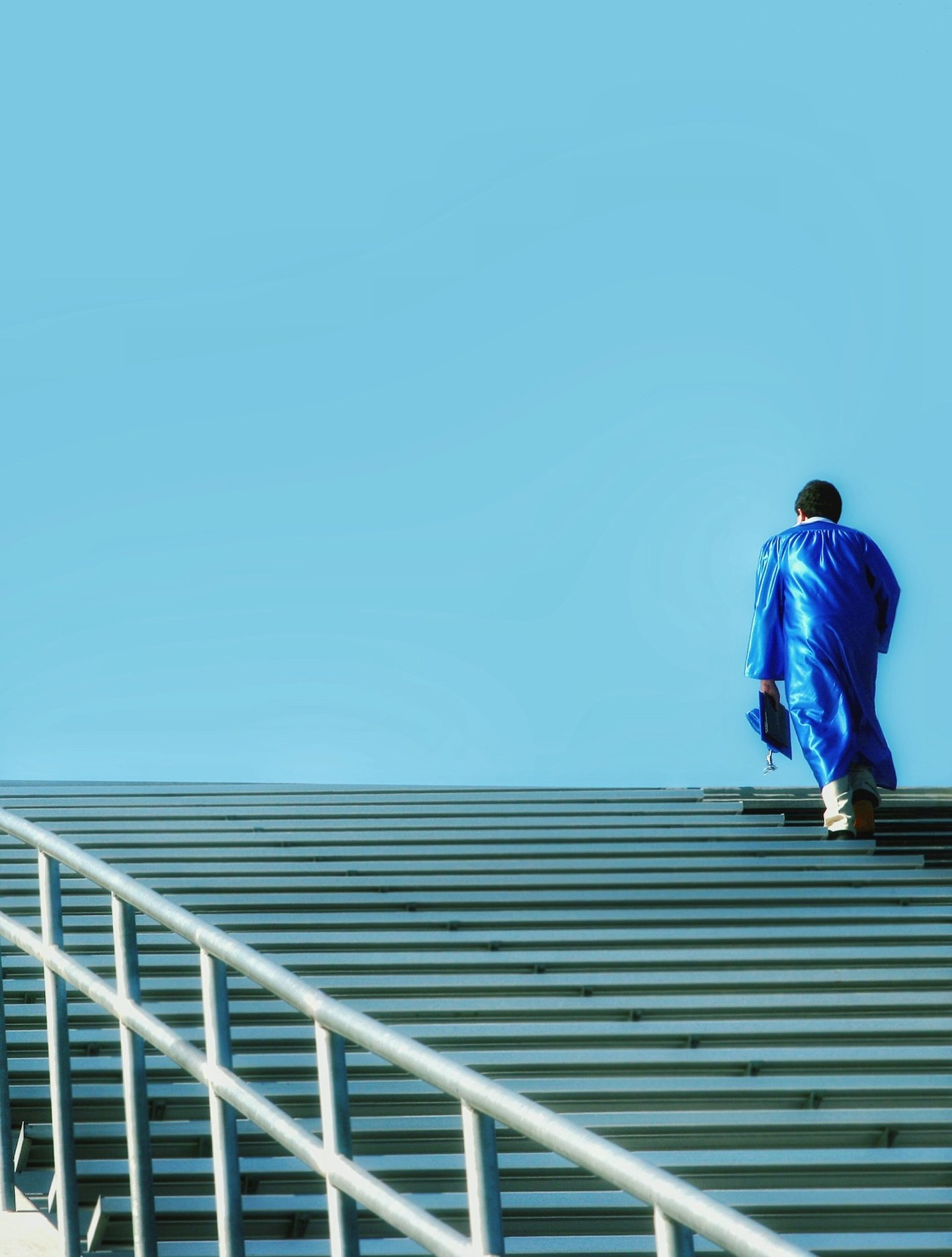a man in a blue suit walking up stairs