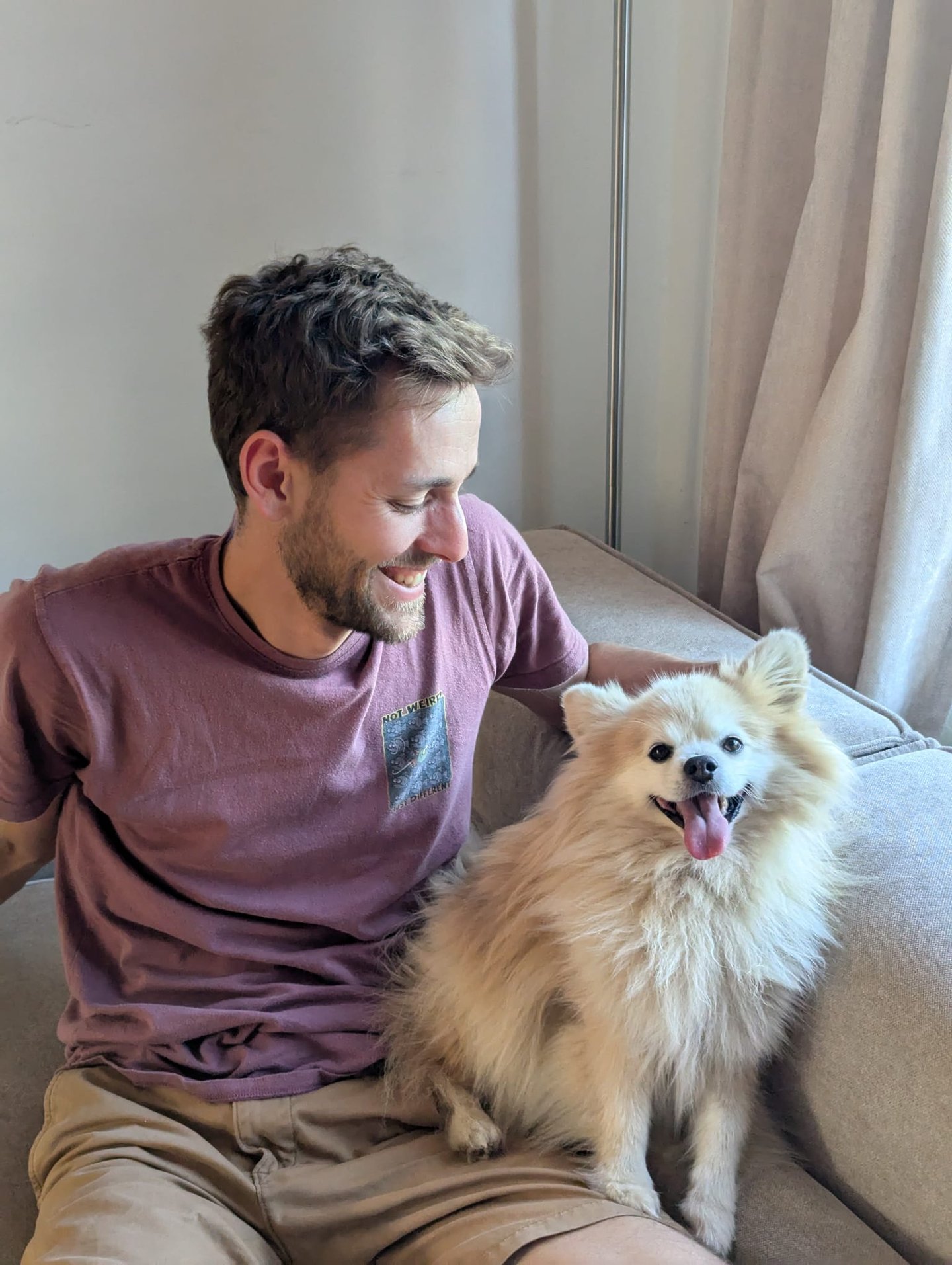 Tom and Lupin the Pomeranian sat on the sofa together