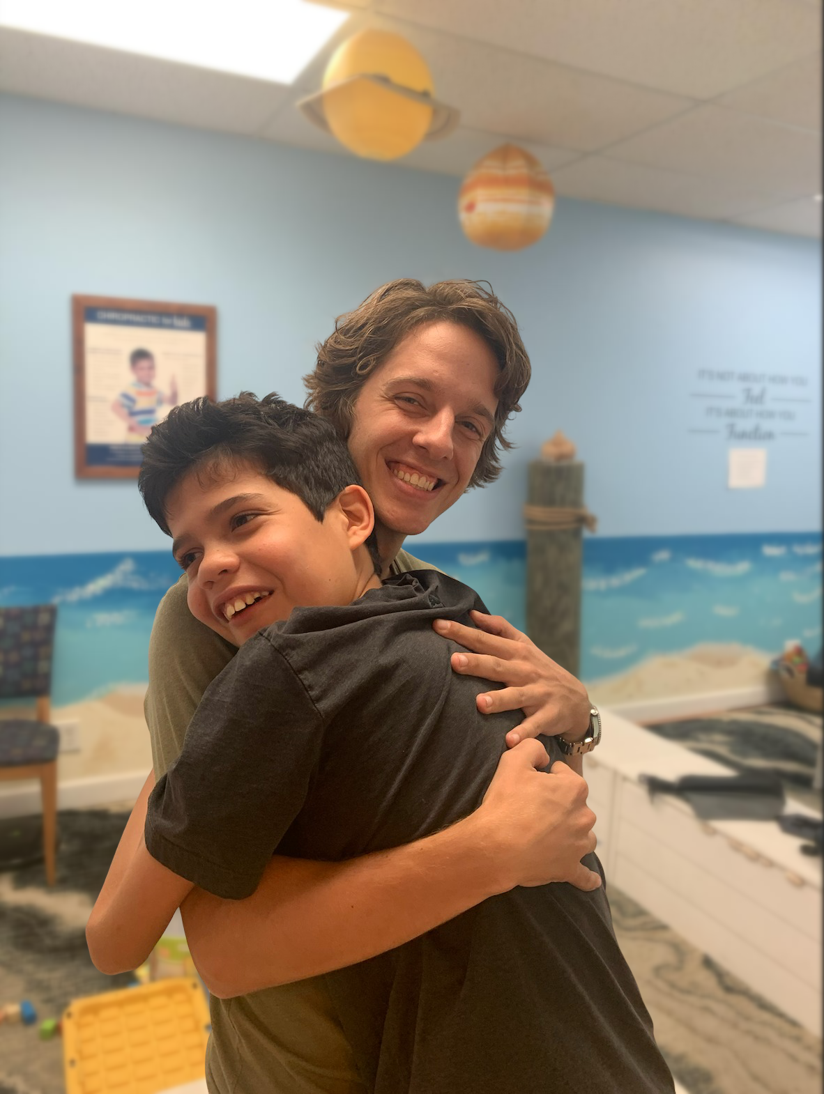 Chiropractor working with special needs to help with speech and motor delays