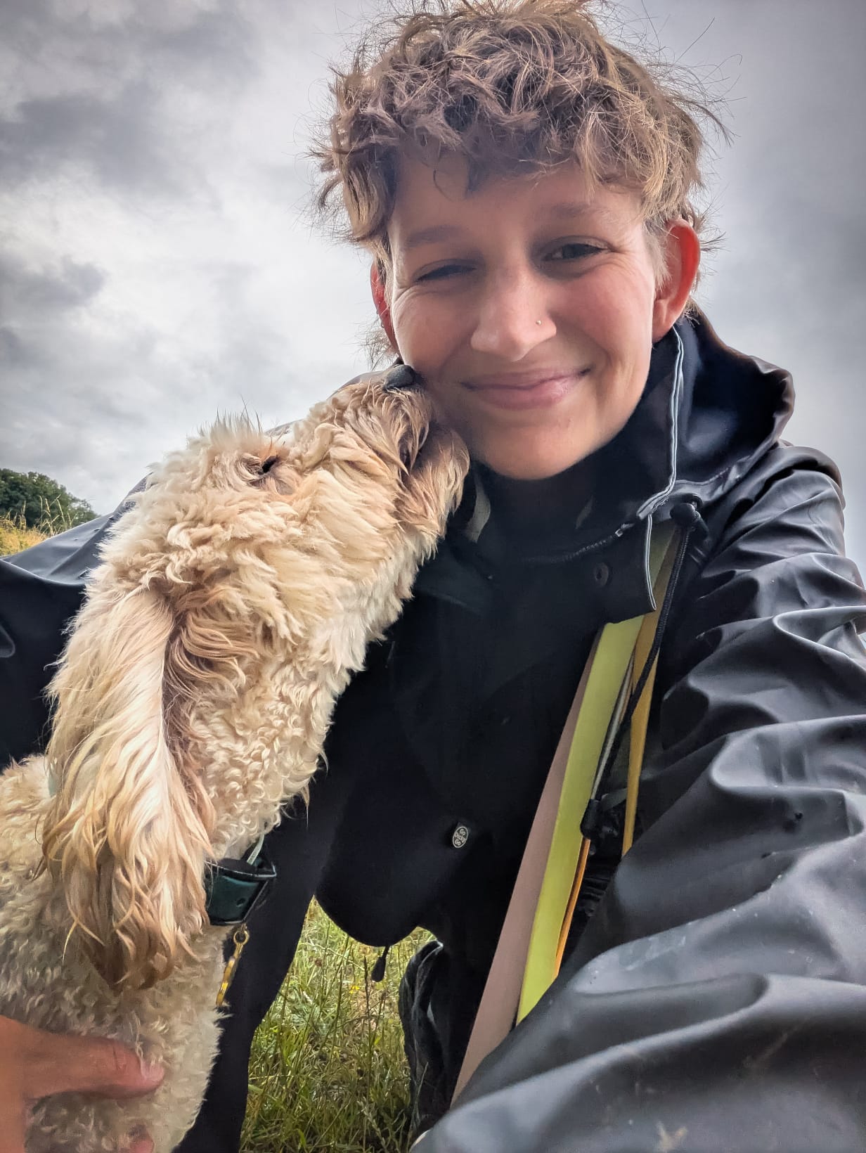 Image of a dog licking a woman's face