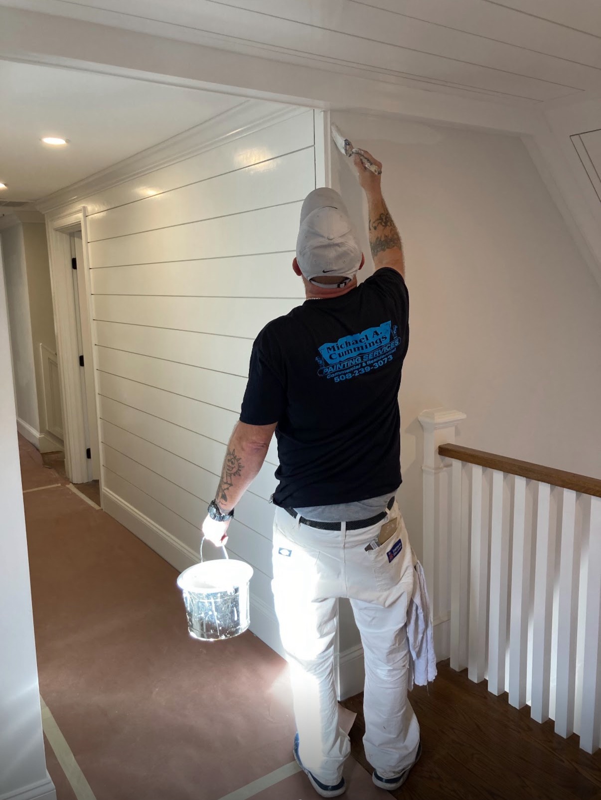 Michael Cummings painting interior walls in Duxbury, MA home using professional brushstrokes