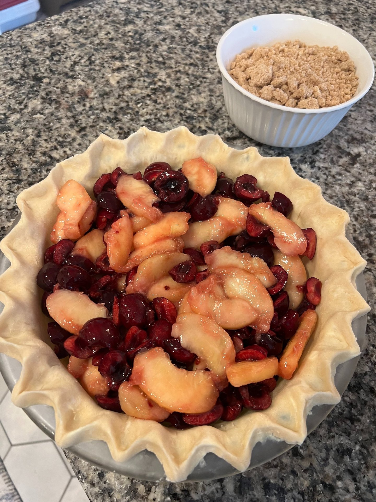 cherries and peaches in an unfinished pie shell
