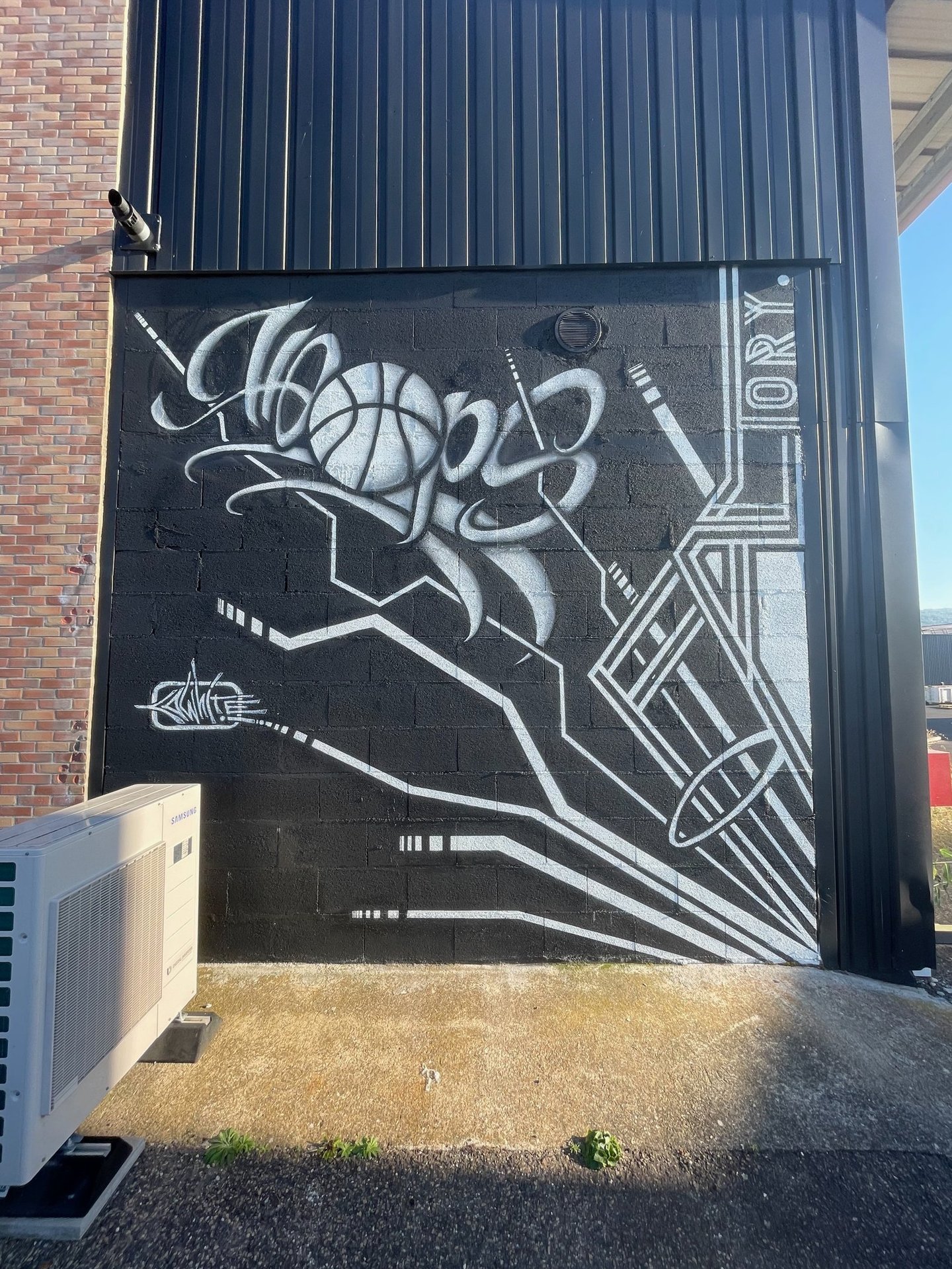 un graffiti noir et blanc avec écrit Hoops Factory 