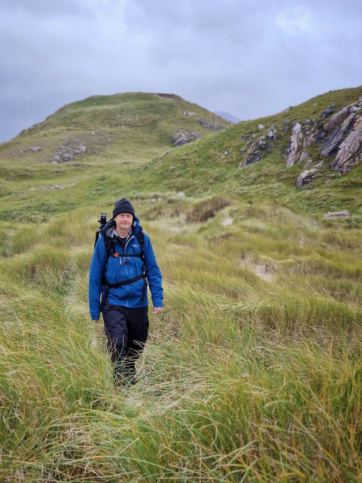 Martin Photography workshop tutor in grass carrying camera bag
