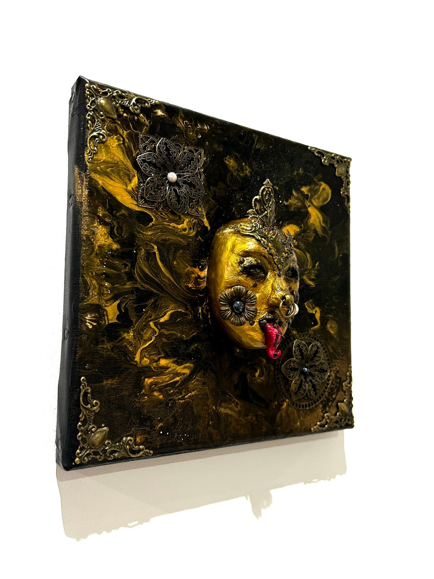 a painting of a gold mask on a white background