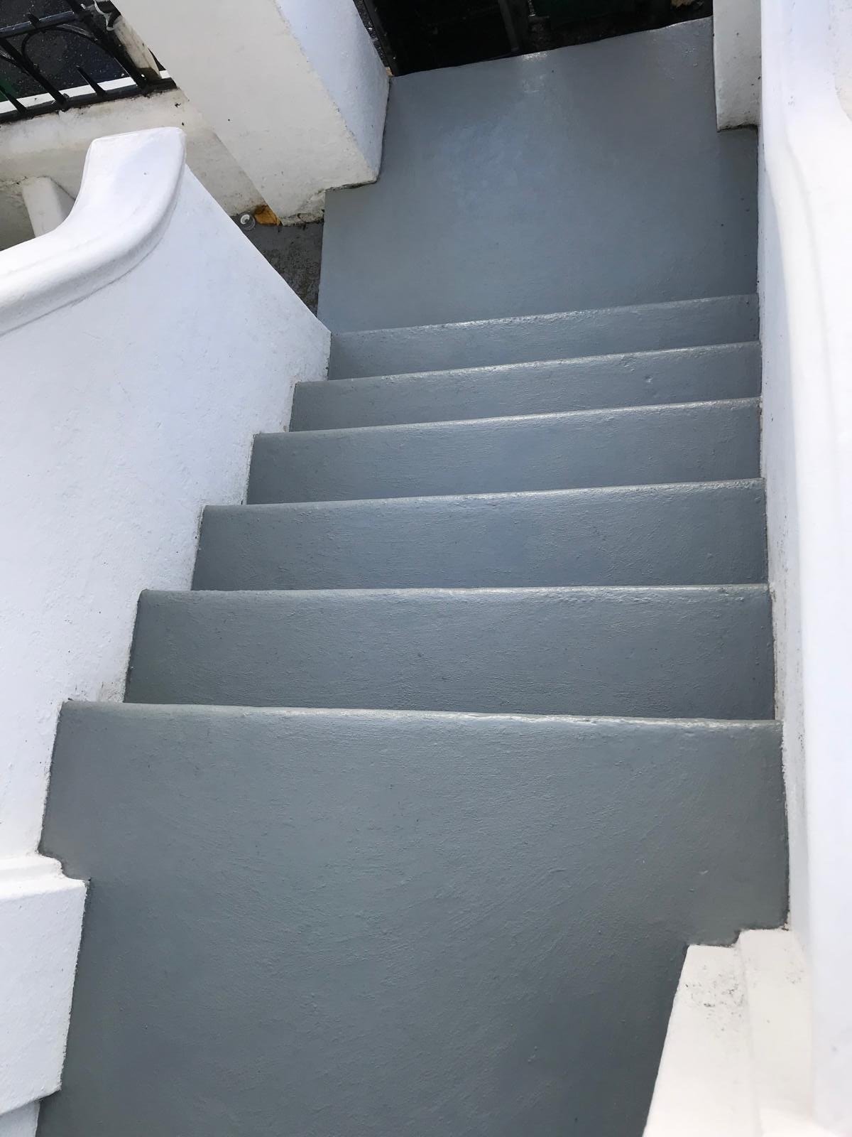 Freshly painted staircase with grey stair treads and white walls in Brighton