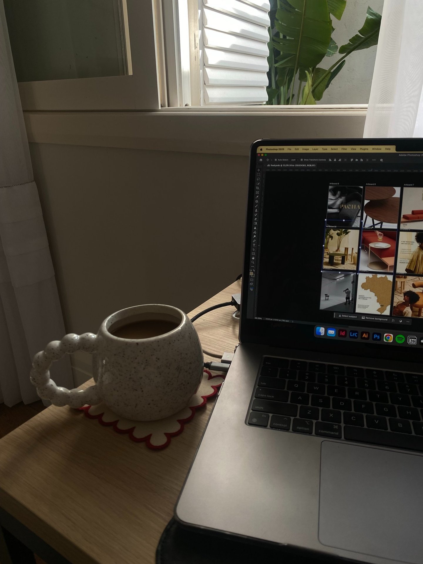 a laptop computer sitting on a table with a cup of coffee