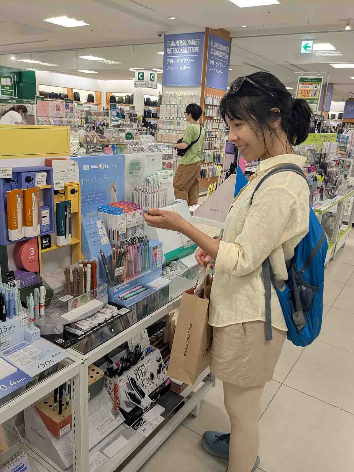 Woman browsing Japanese stationery and pens in a department store in Shizuoka, Japan.