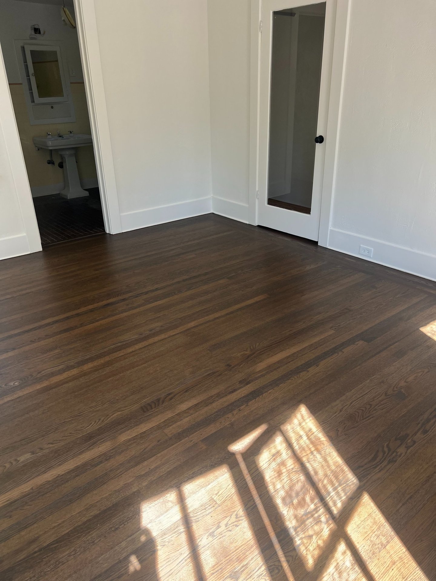 a room with a wooden floor and a door