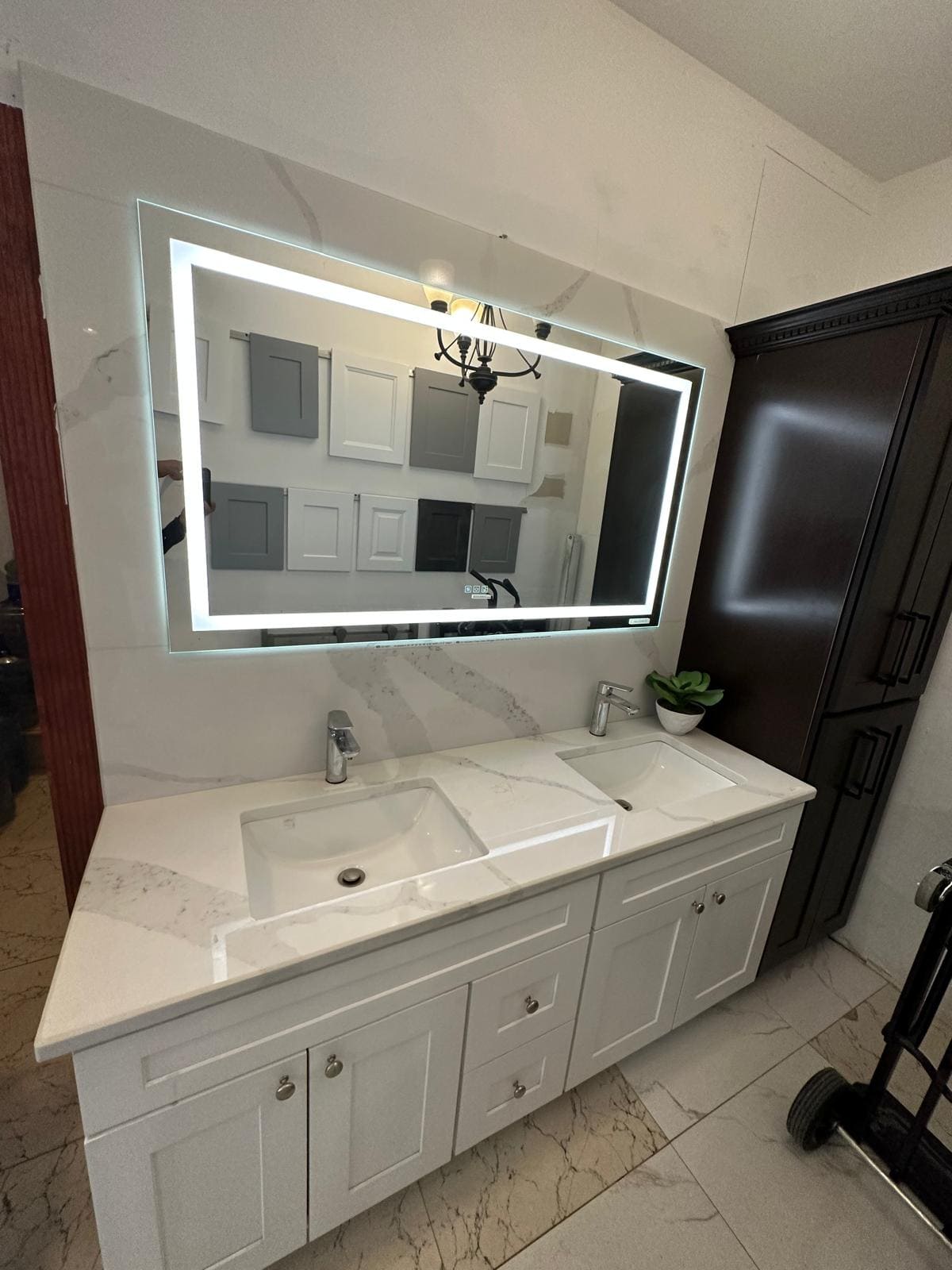 a bathroom with a large mirror and a chandelier