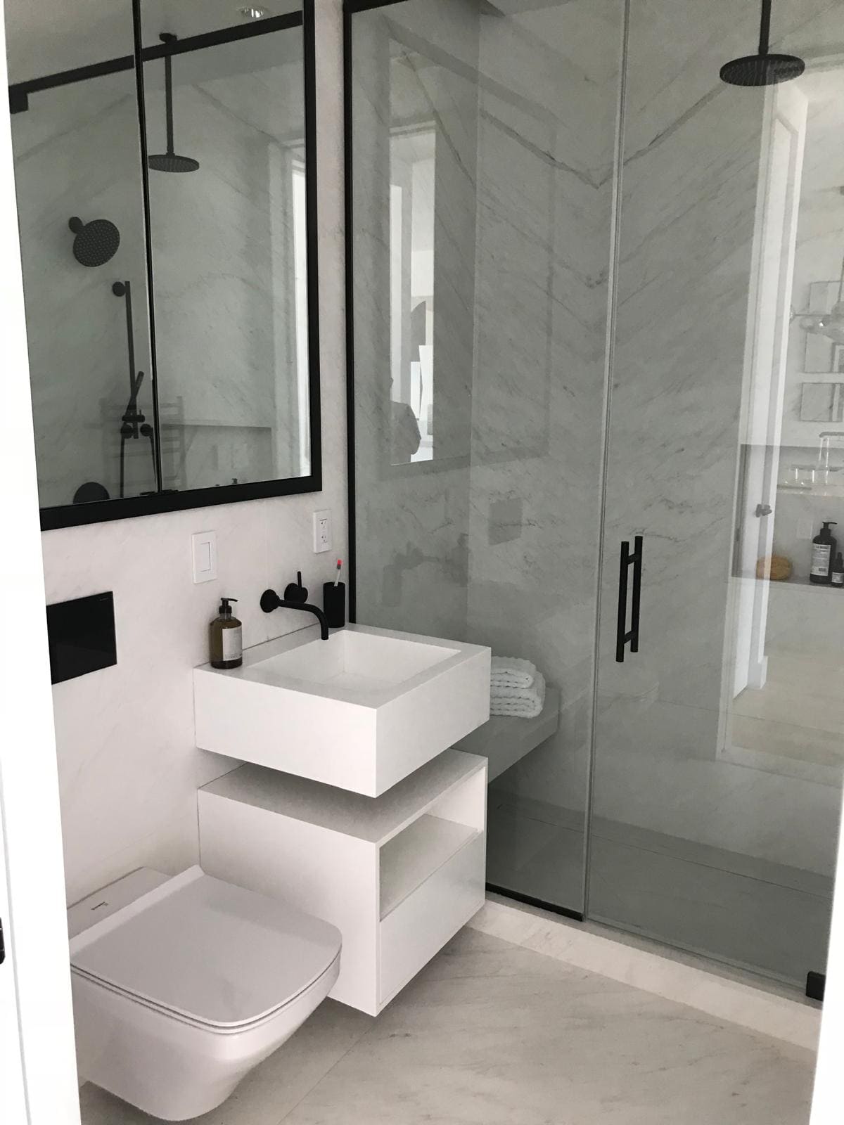a bathroom with a toilet and a shower