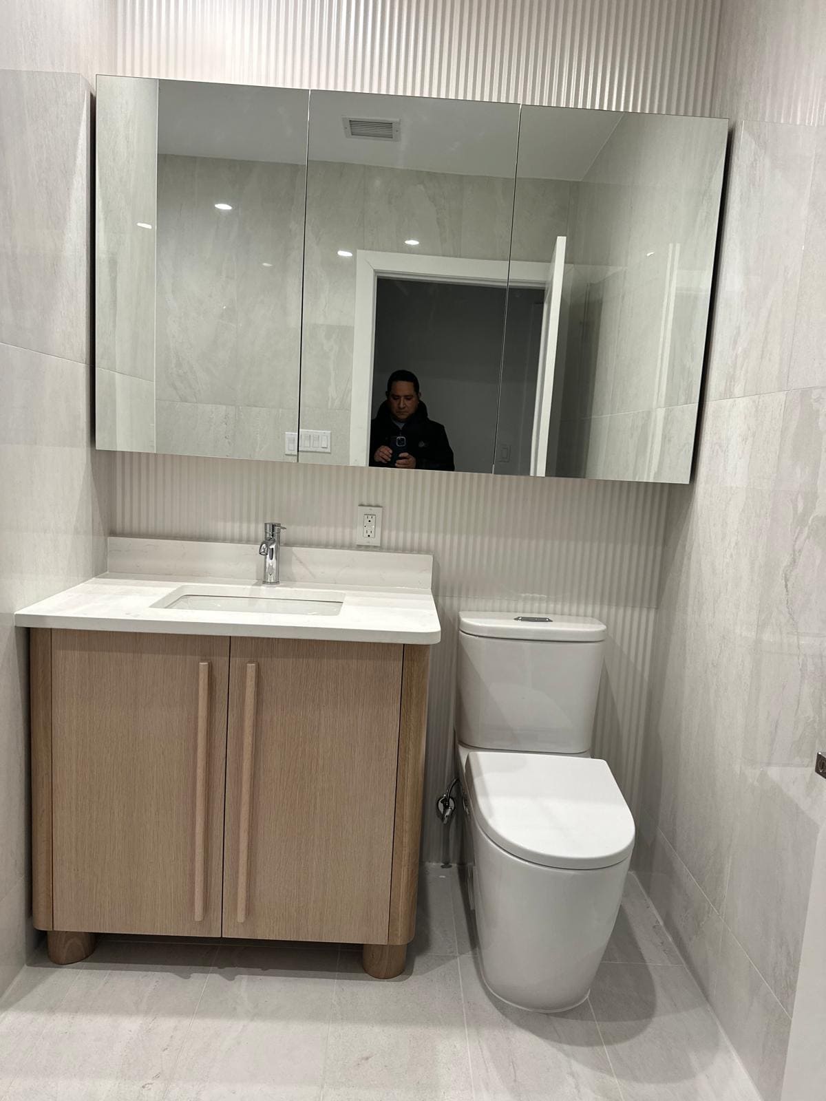 a bathroom with a toilet and a mirror