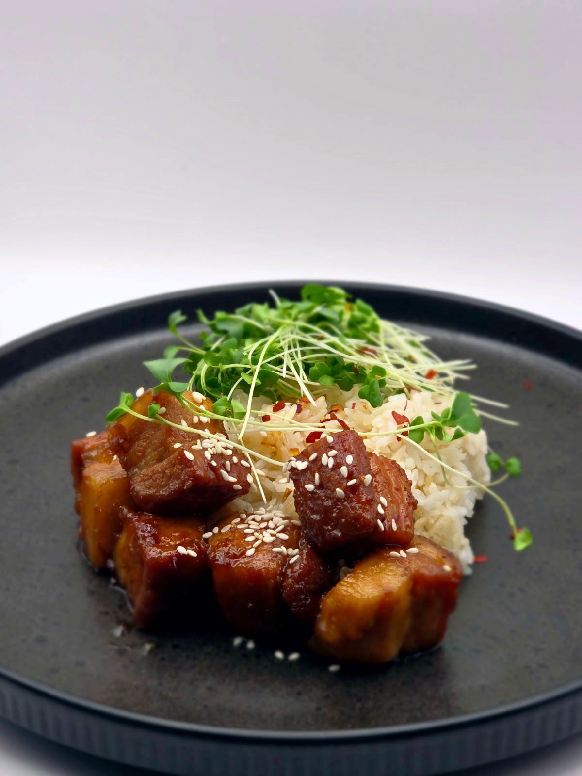 a plate of food with meat and rice