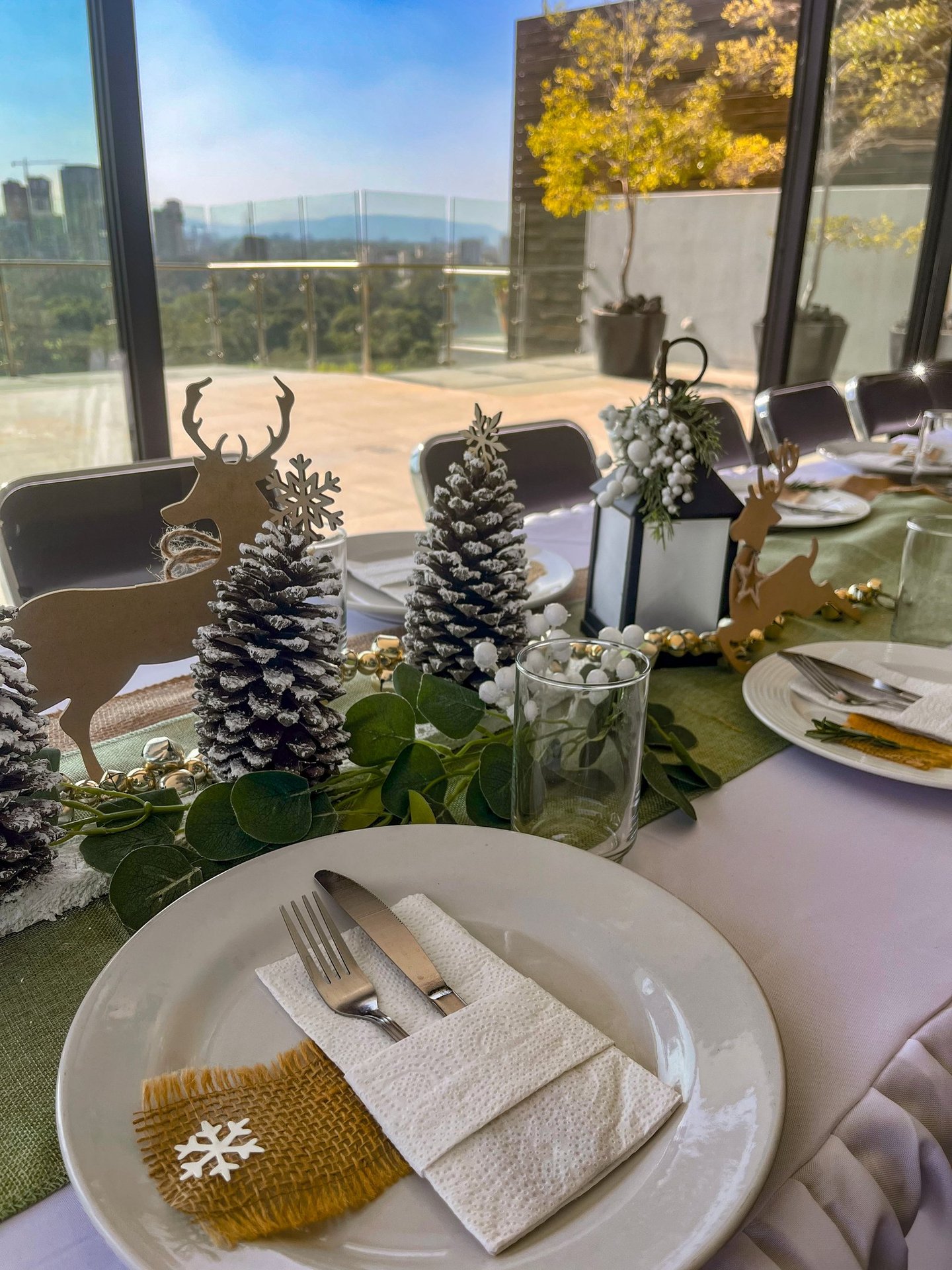 a table setting with pine cones and pine cones
