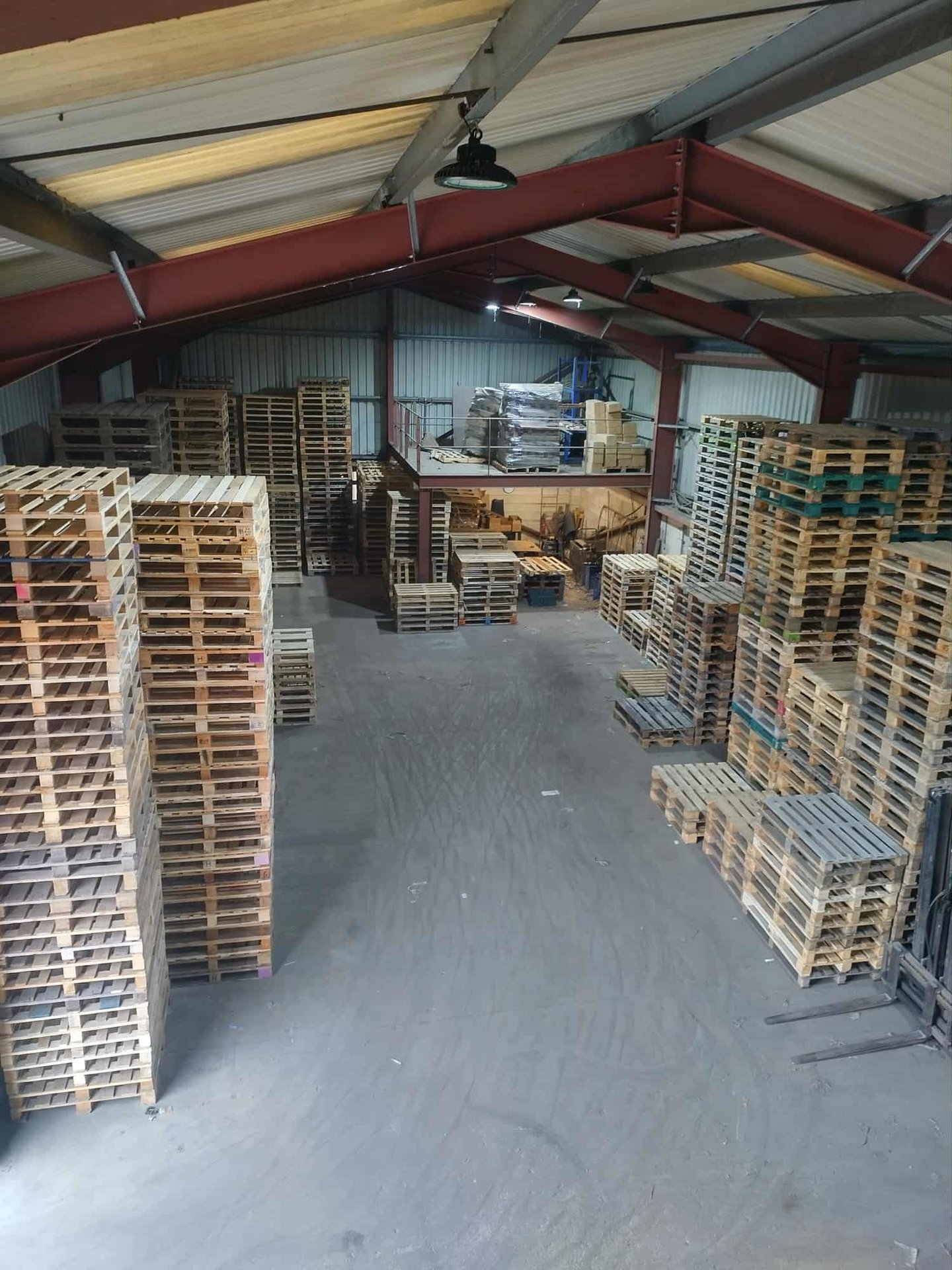 Warehouse with repaired pallets stacked up