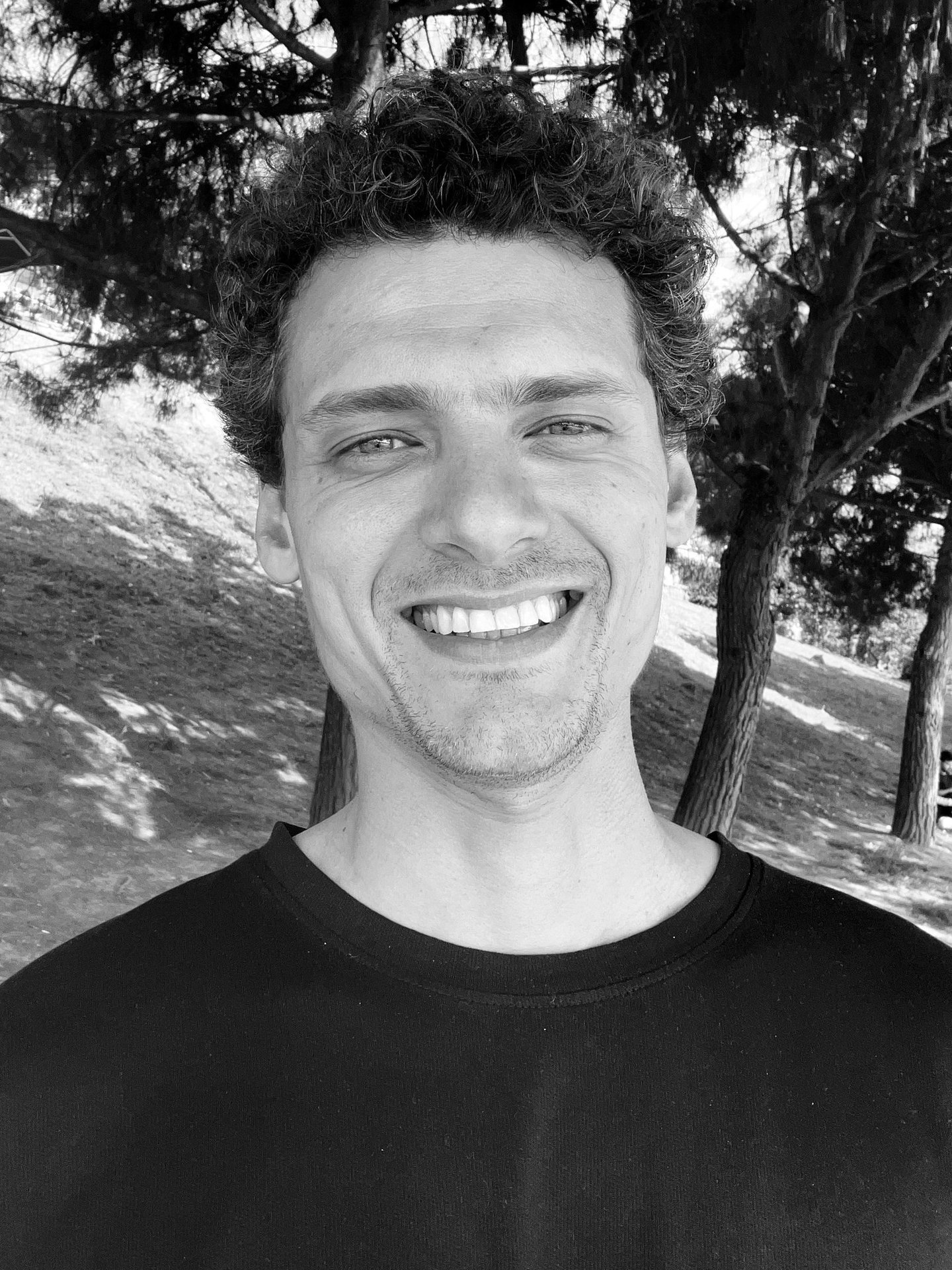 Aybars Düzey, Tai Ji and Qi Gong instructor at WDP Türkiye, smiling outdoors in natural light.
