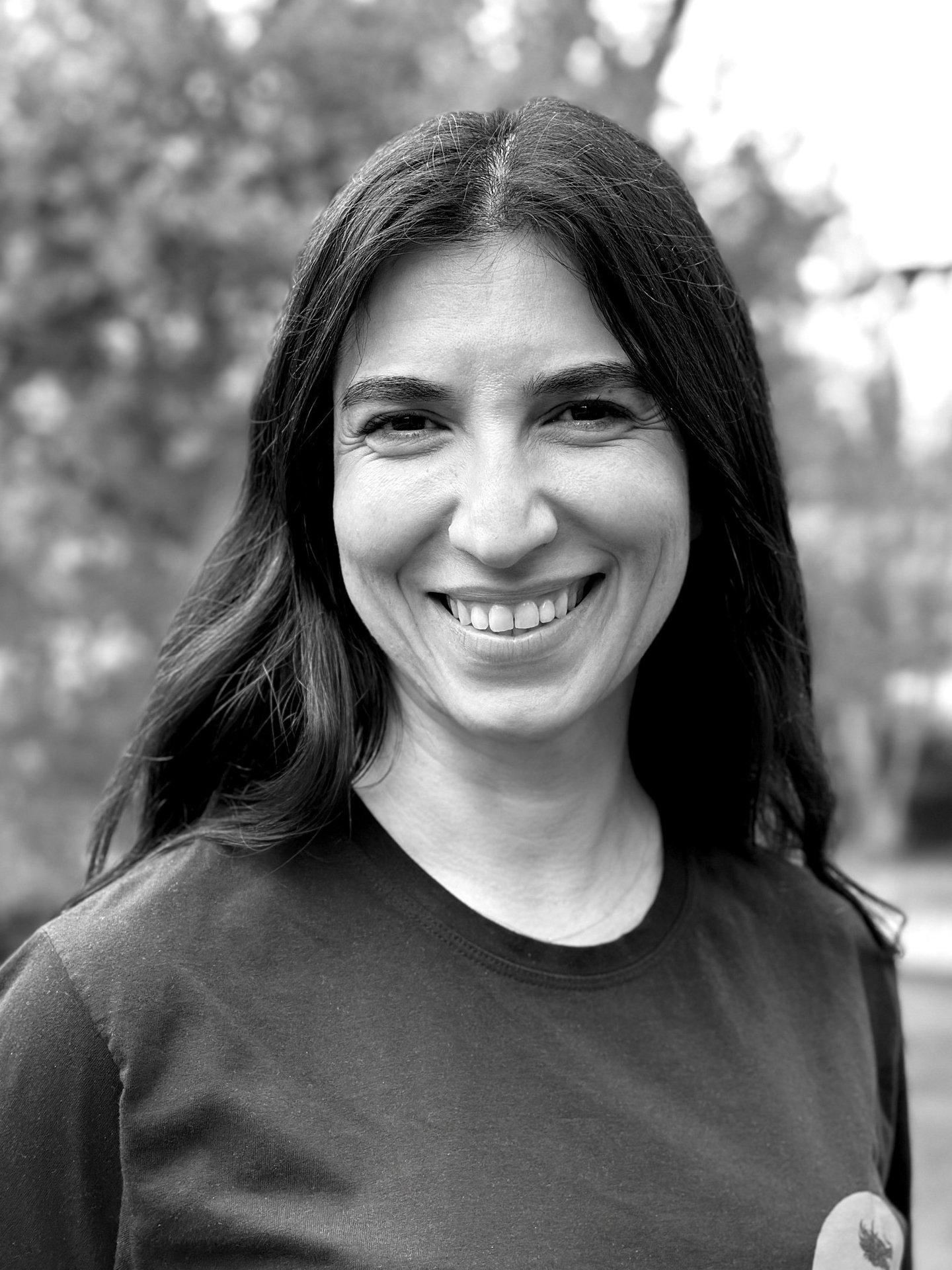 Bilge Demirkazan Tai Ji Qi Gong instructor of WDP Turkey, smiling outdoors in black shirt