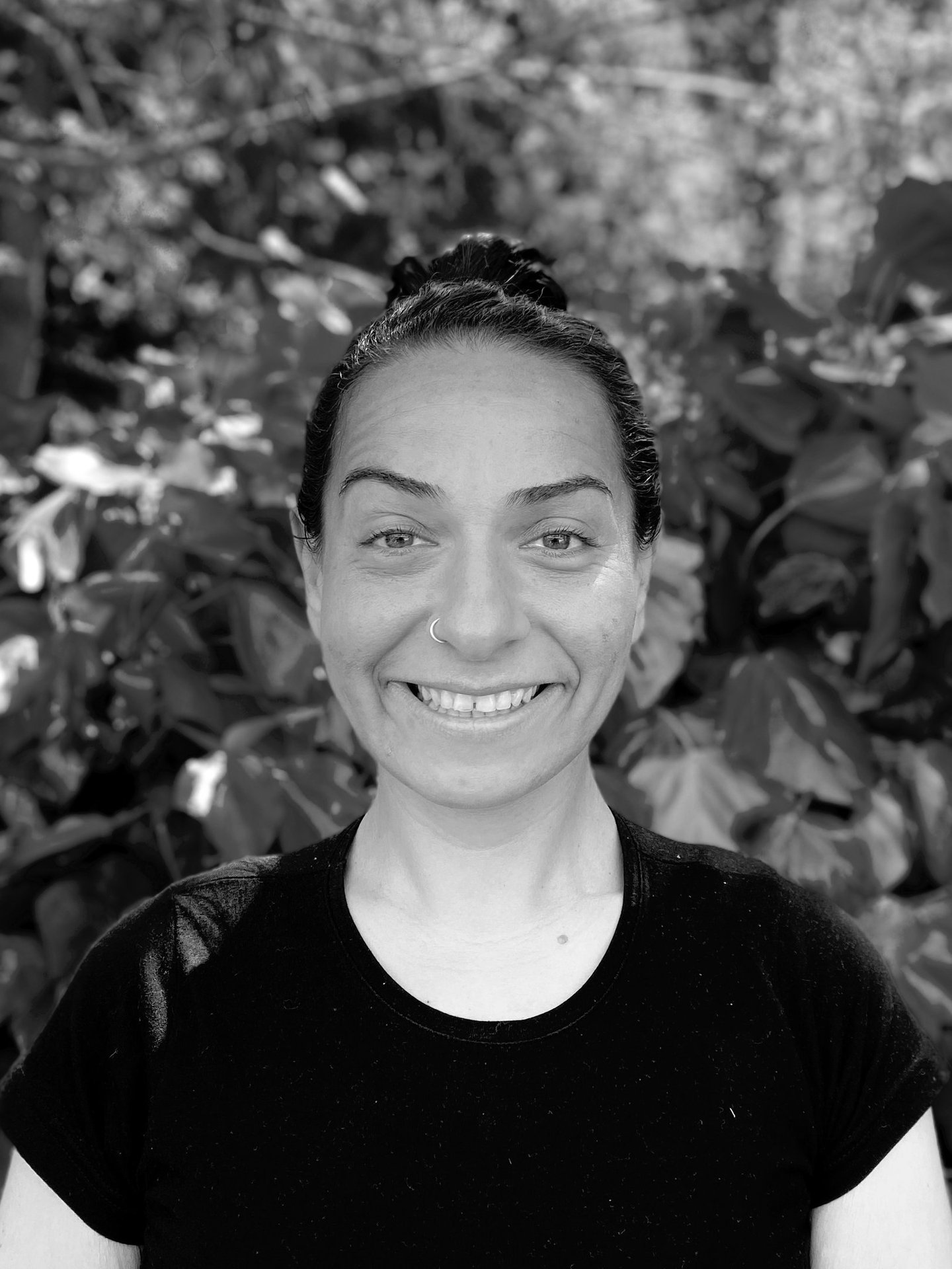 Ebru Tütek, Tai Ji and Qi Gong instructor at WDP Türkiye, smiling outdoors in a forest setting.