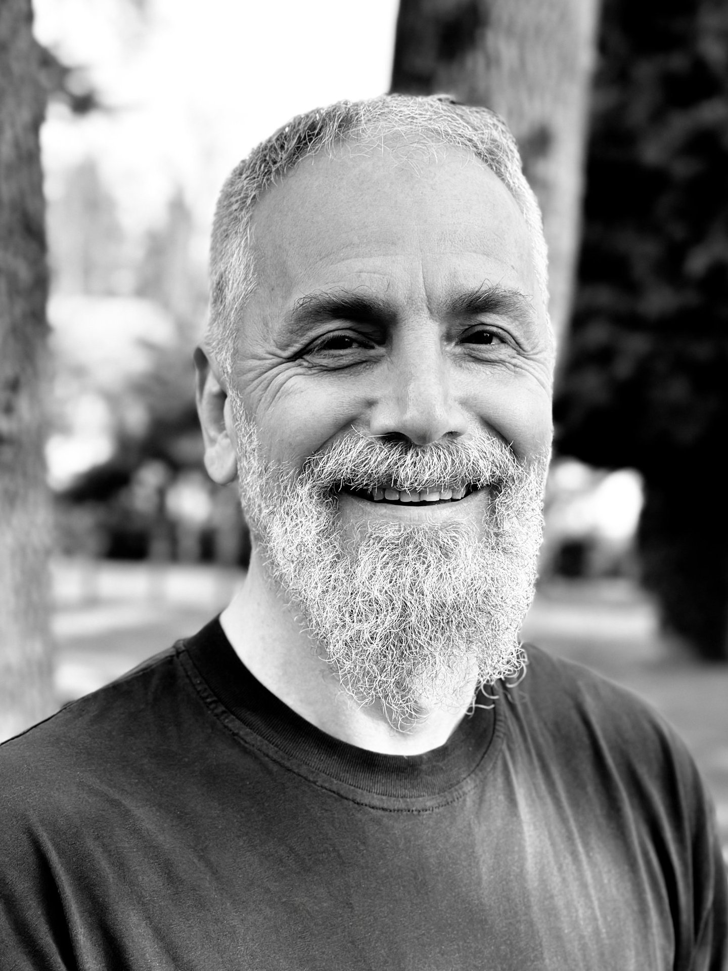 Harun Mehmet Soydan Tai Ji Qi Gong senior instructor of WDP Turkey, smiling outdoors in black shirt