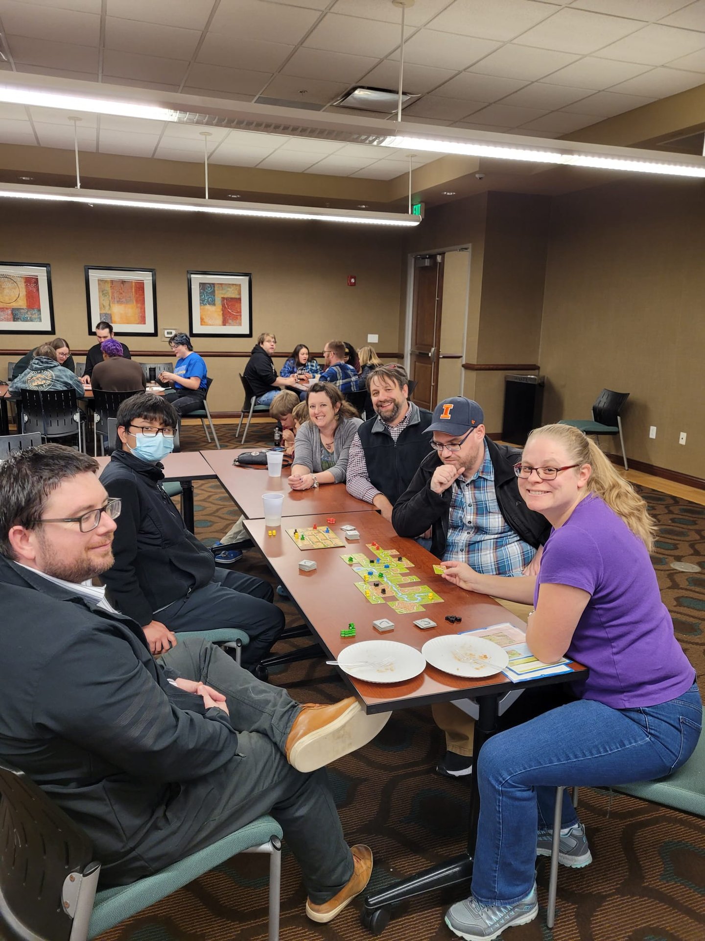 Dr. Hooton, history faculty, and students playing board games.
