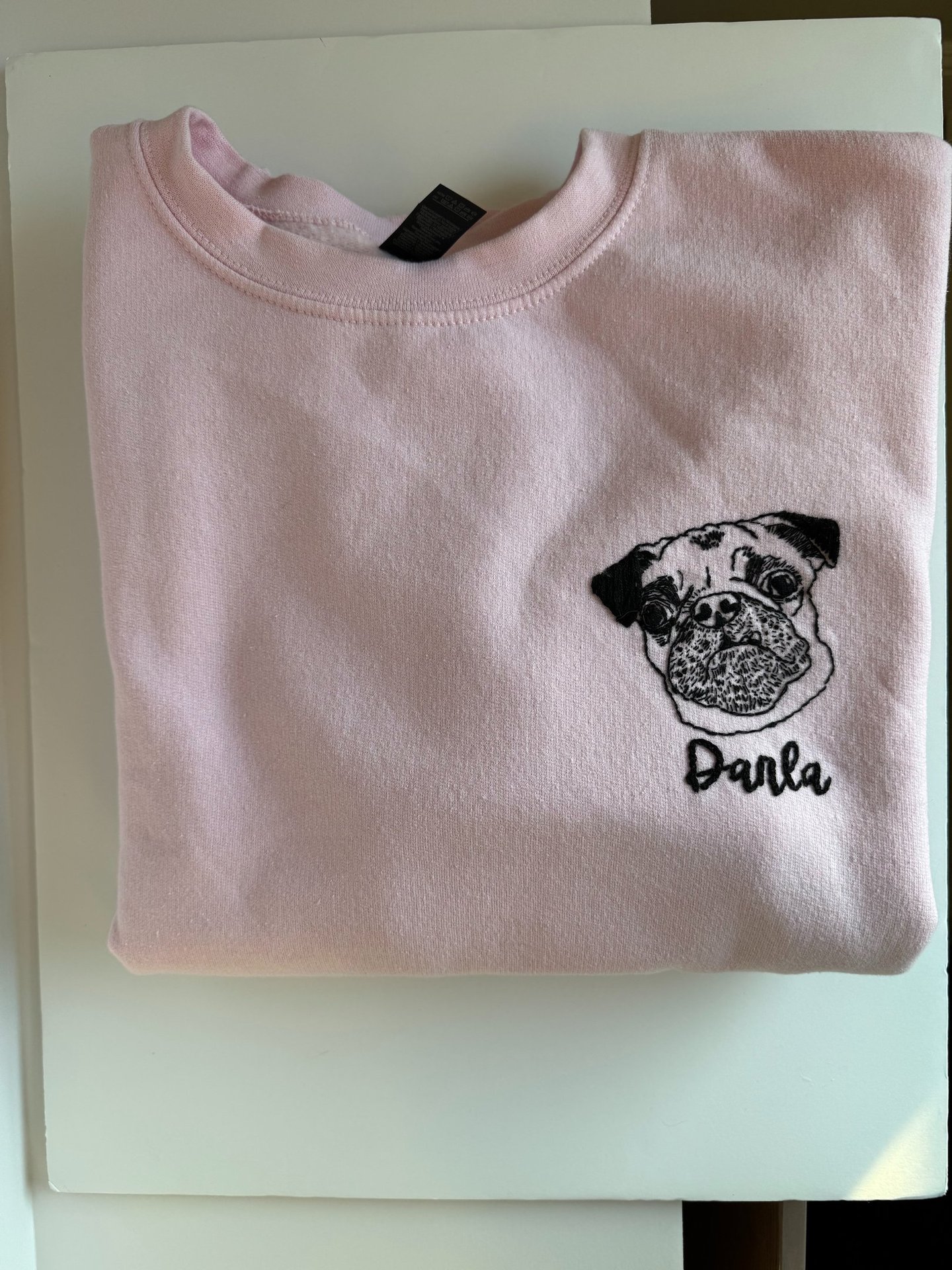 a pink shirt with a pug dog on it