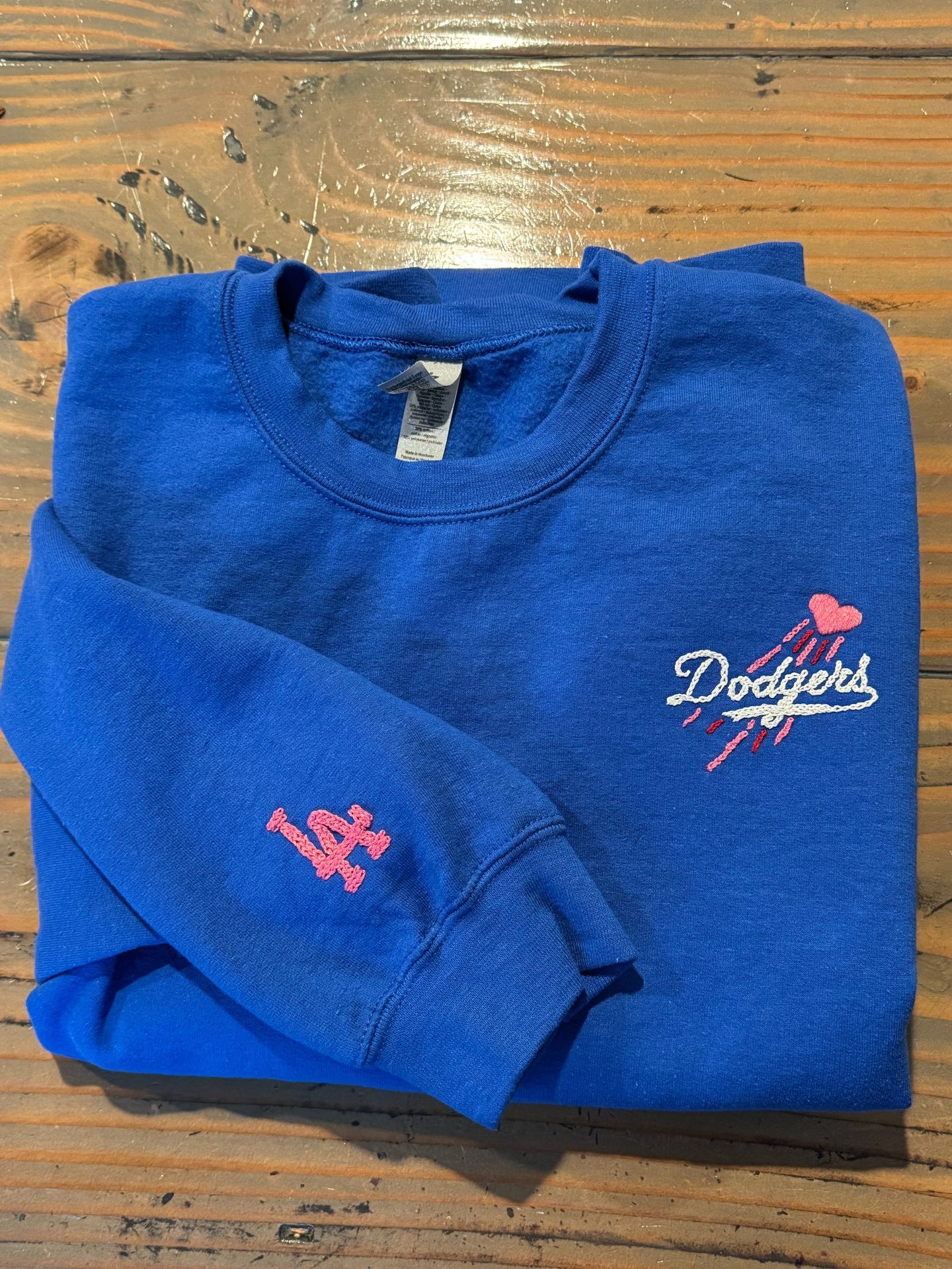 a blue sweatshirt with the dodgers logo on it