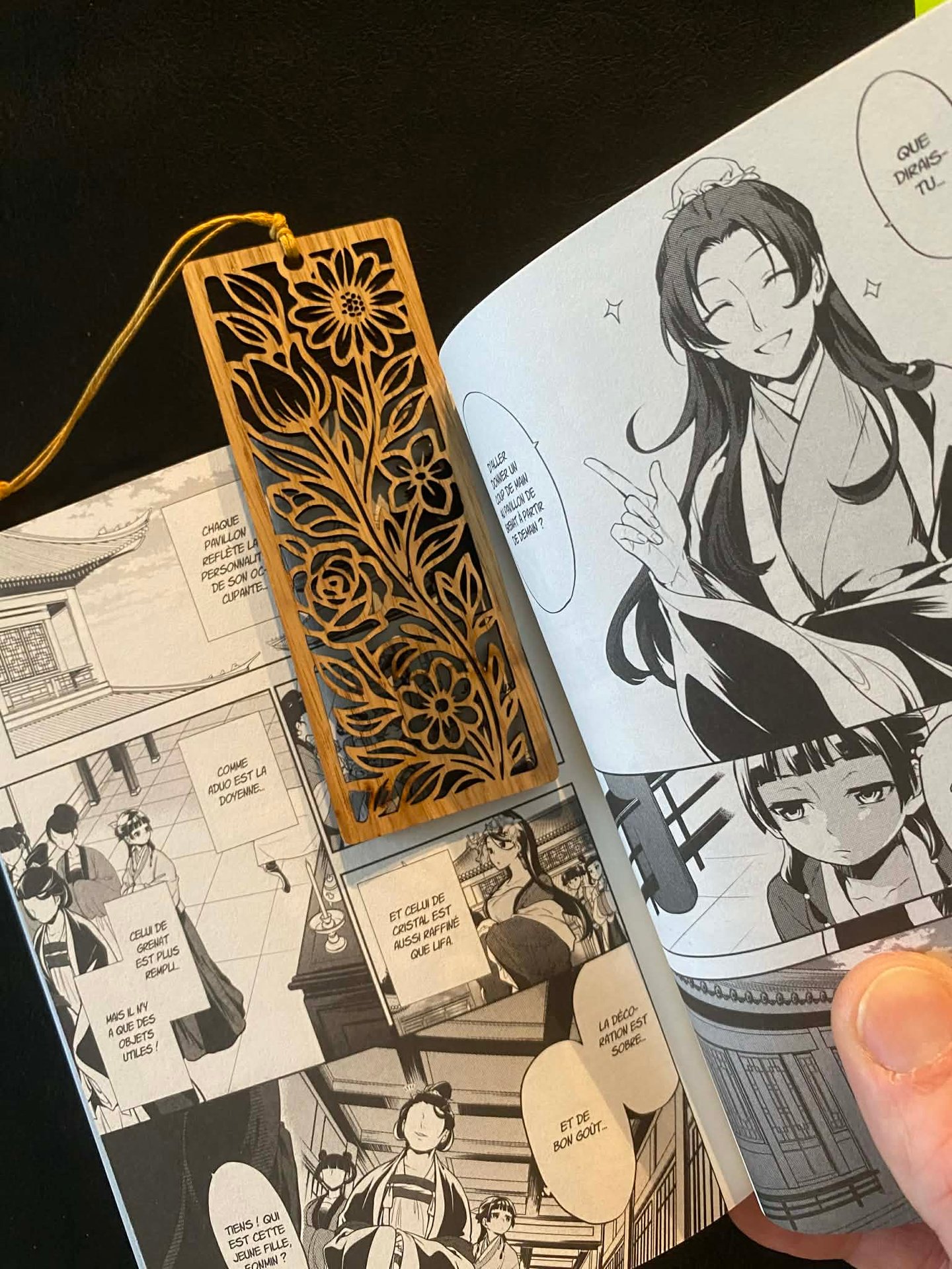 a person holding a book with a bookmark
