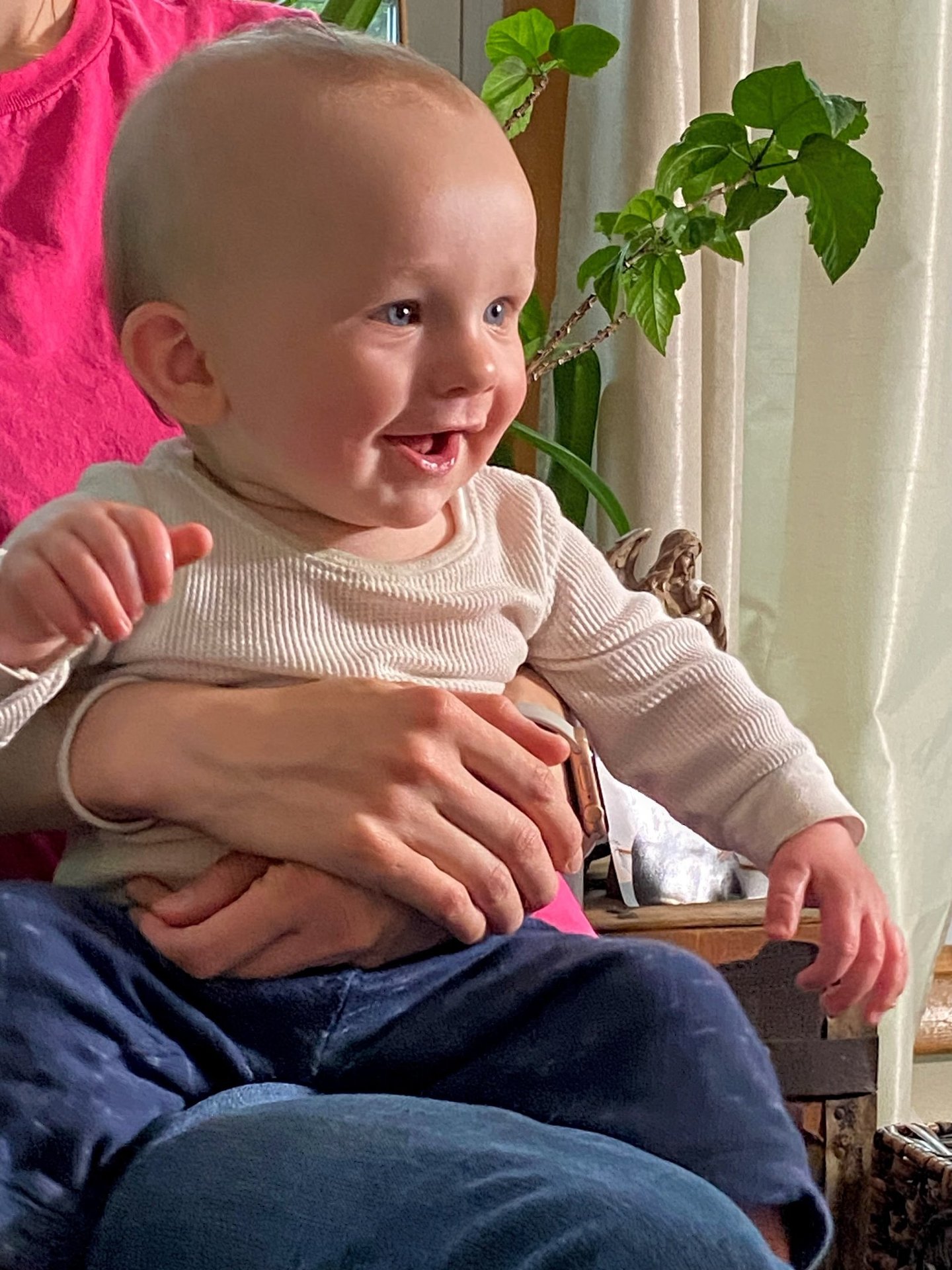 a nine month old smiling baby