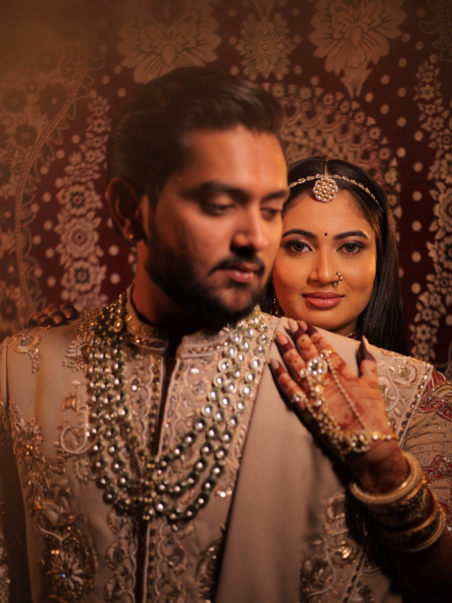 Romantic pre-wedding portrait of a smiling Indian bride with eyes closed, highlighting her glowing b