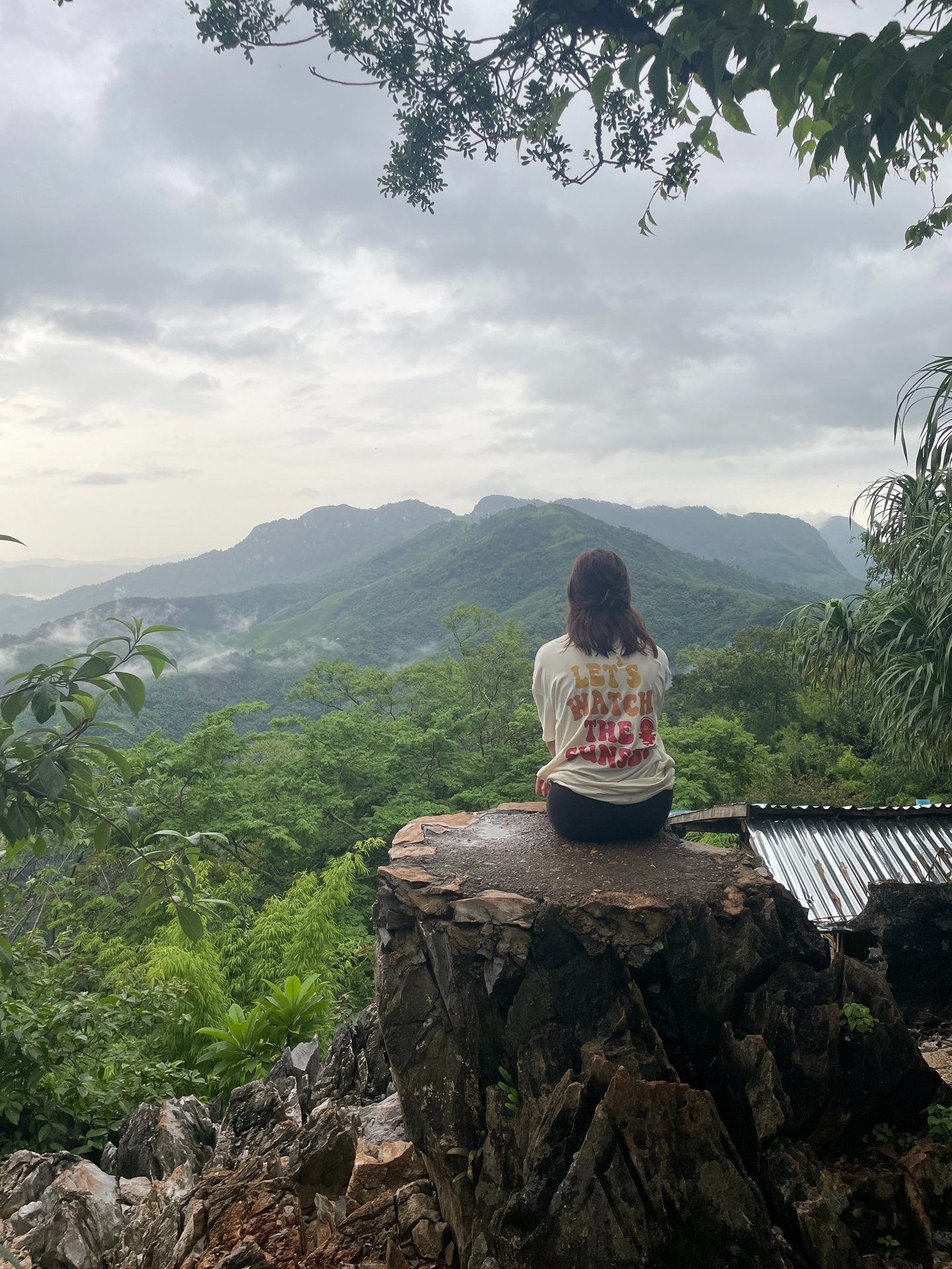 Girl on mountain watching the view at Ngoi