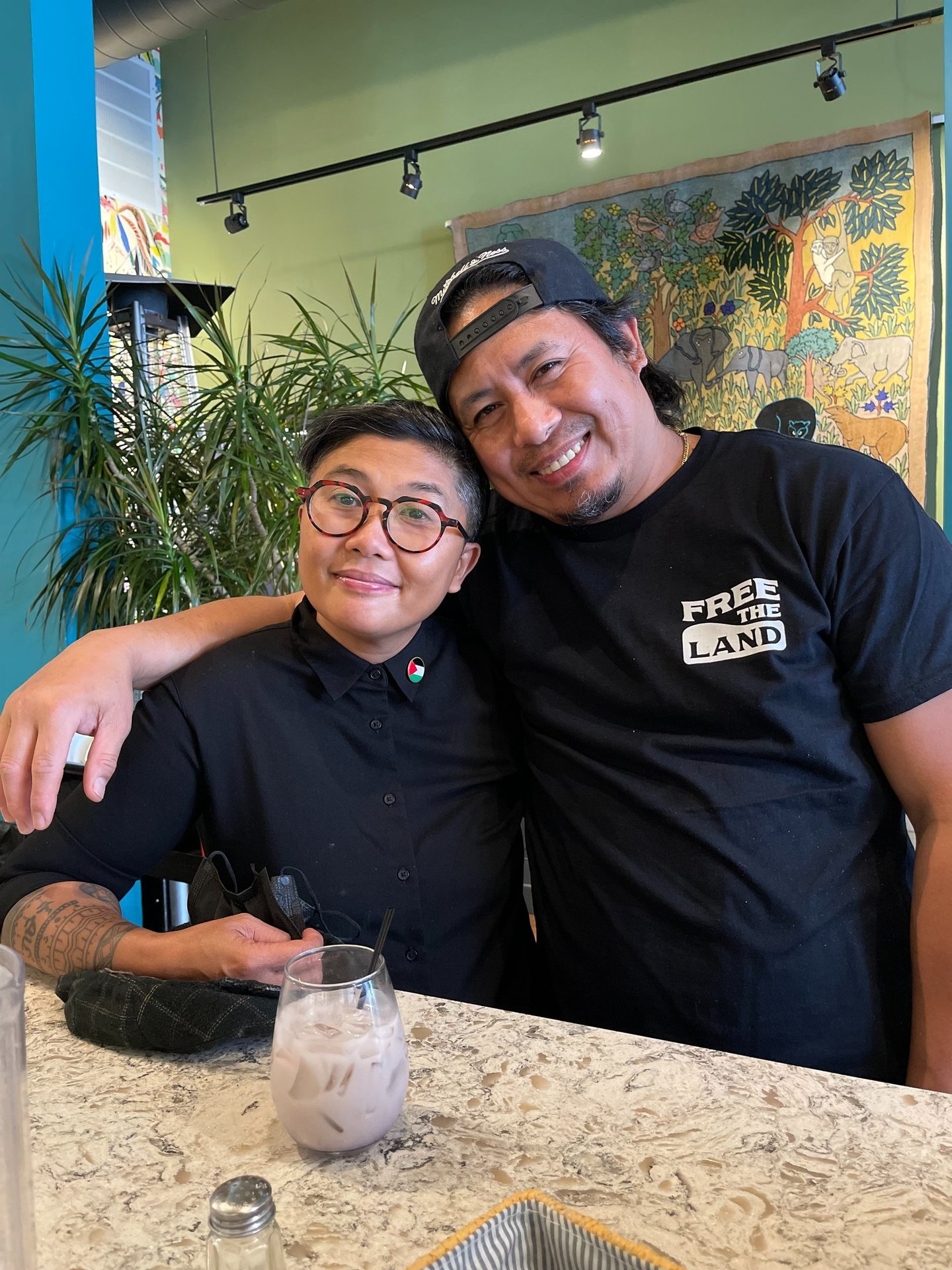 two understory collective participants standing in front of a table