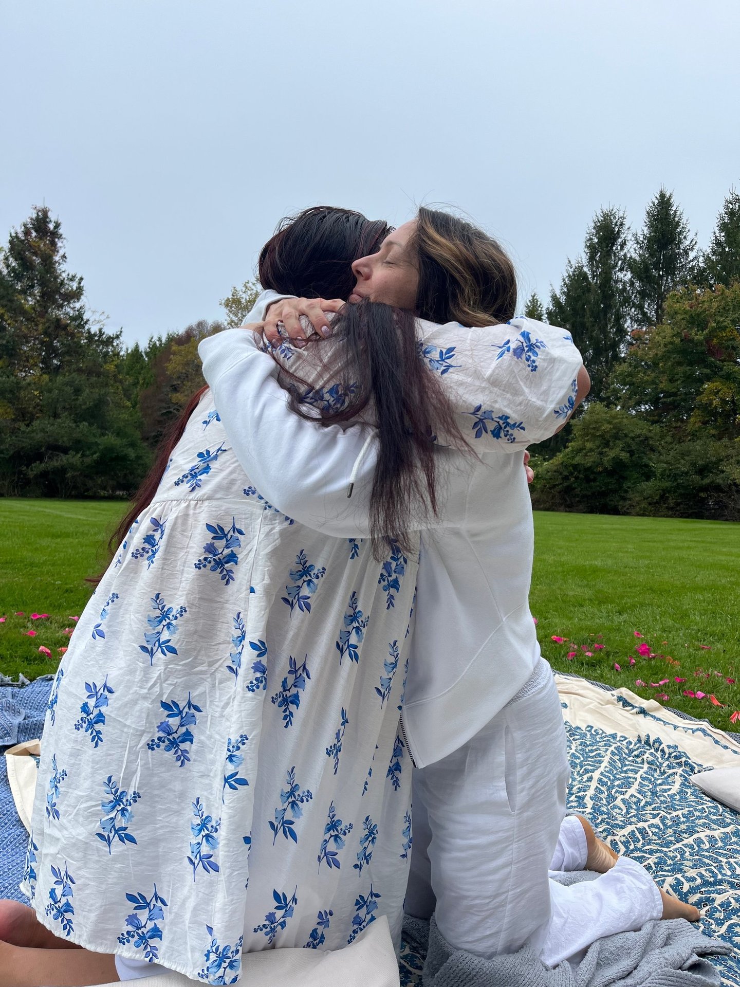 Two women embrace during ceremony