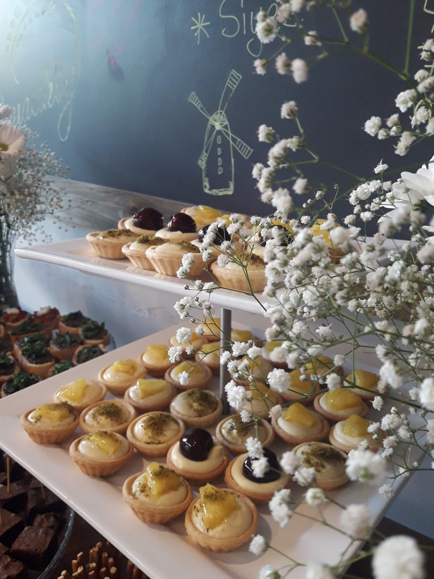 A colorful display of assorted homemade cookies and tarts arranged invitingly on a plate