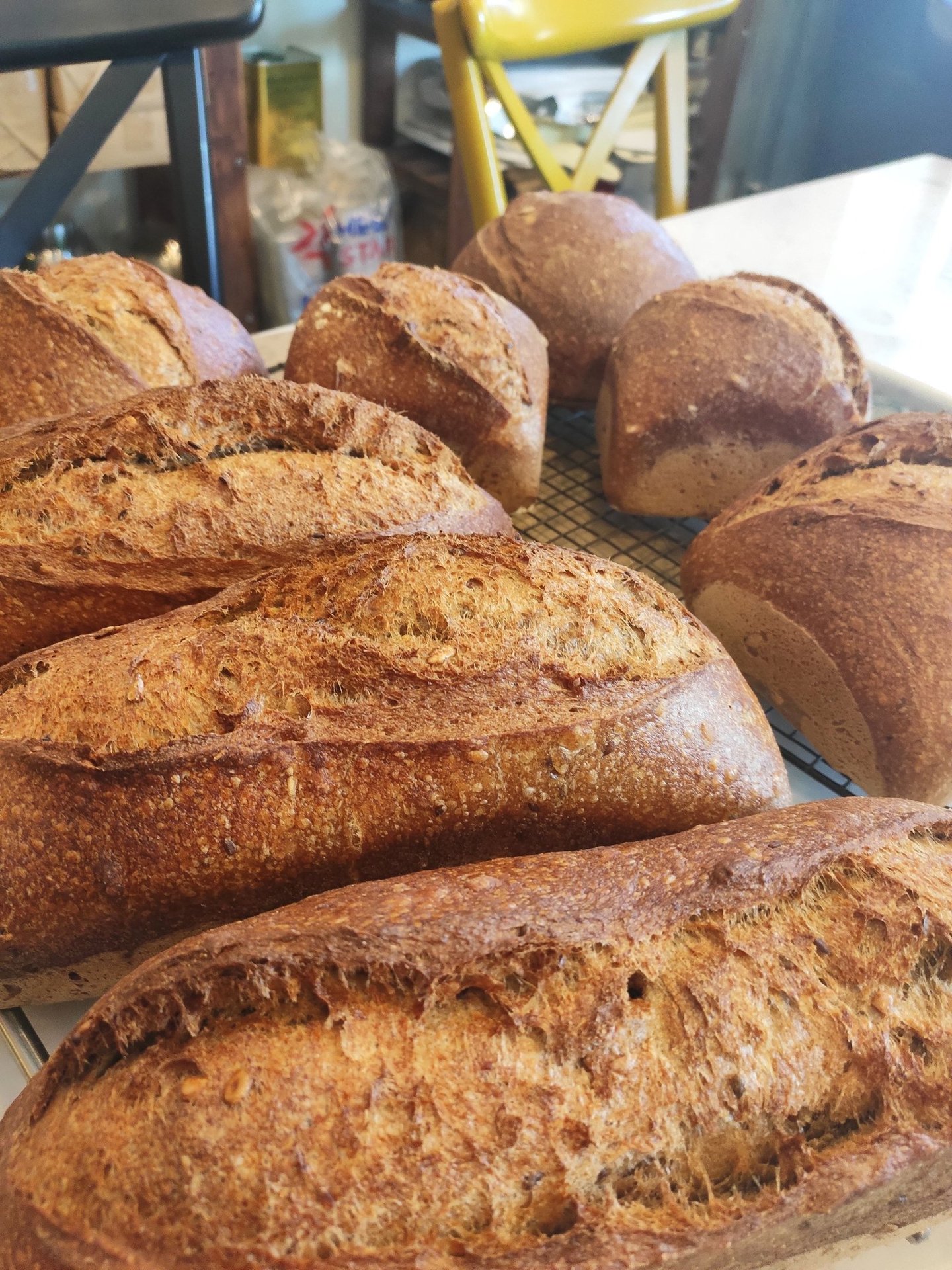 a bunch of breaded breads on a cooling rack