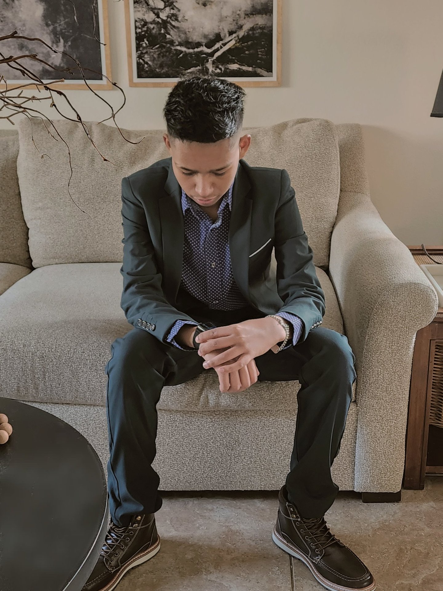 Young Creator and Neurodivergent artist wearing a suit and checking time