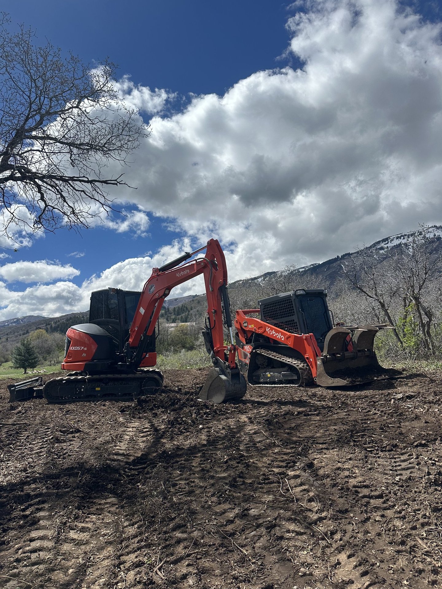 Kubota KX057-s excavator and Kubota skid steer sitting idle on dirt project