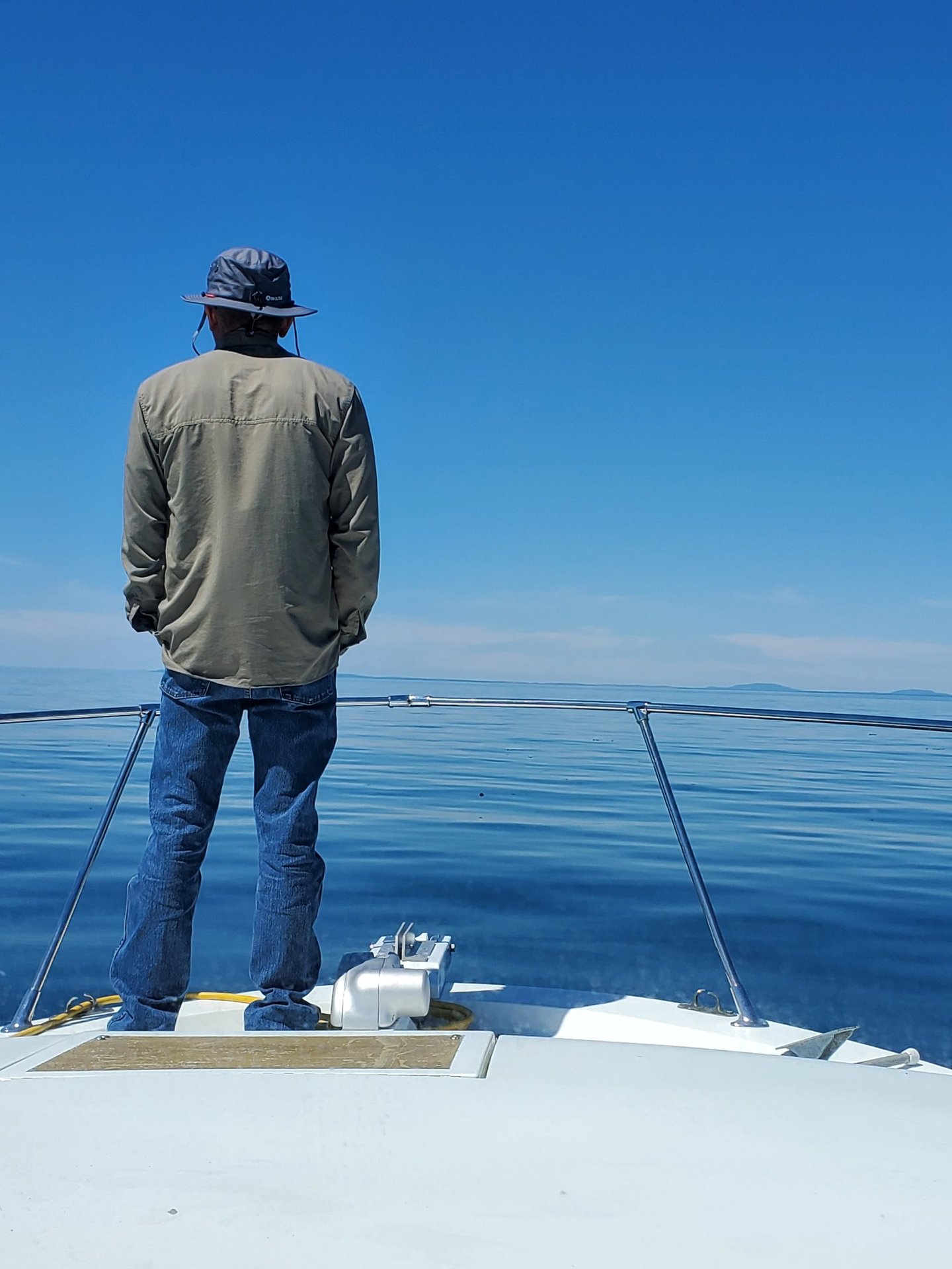 a man standing on a boat in the ocean