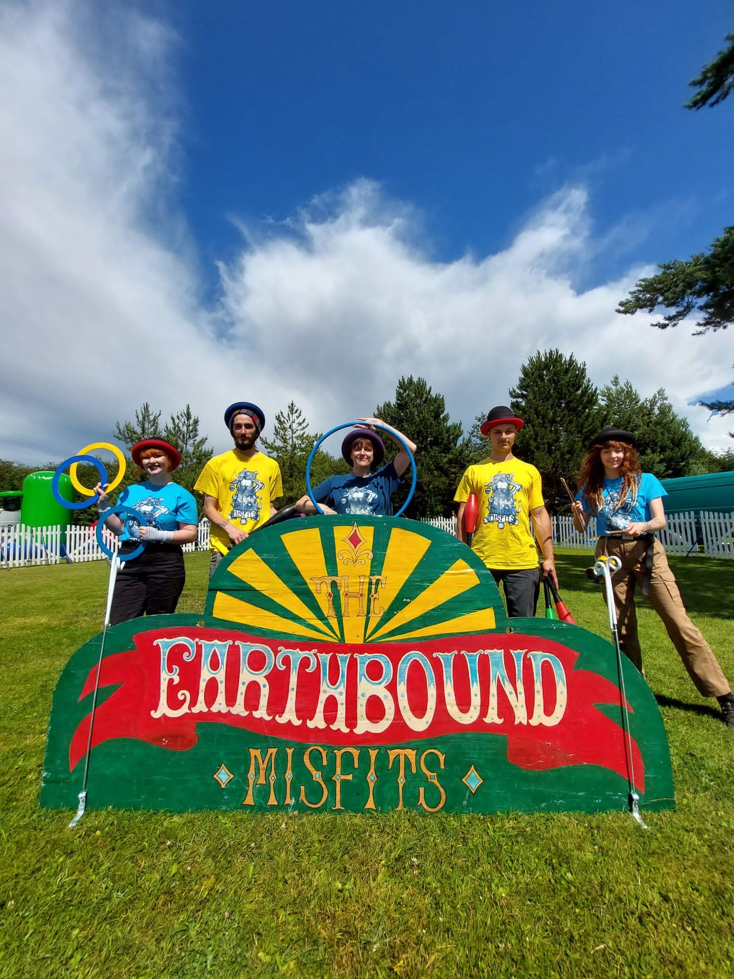 The Earthbound Misfits workshop team performing outdoor juggling and hula hoop skills.