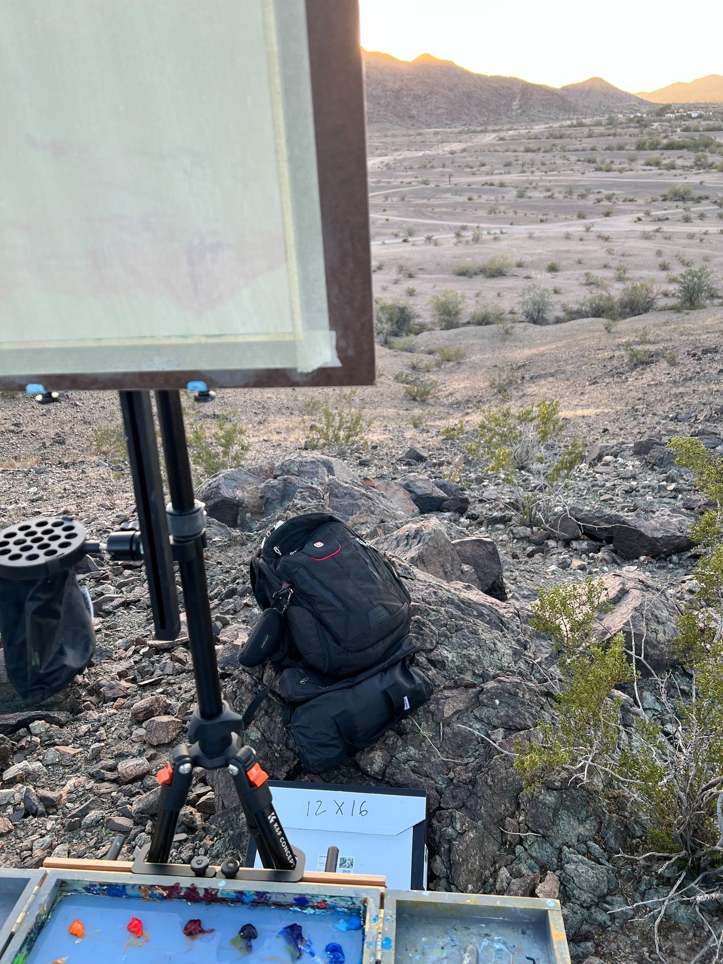 Forensic field gear on granite. Tripod, tactical pack, and log box with technical HUD callouts