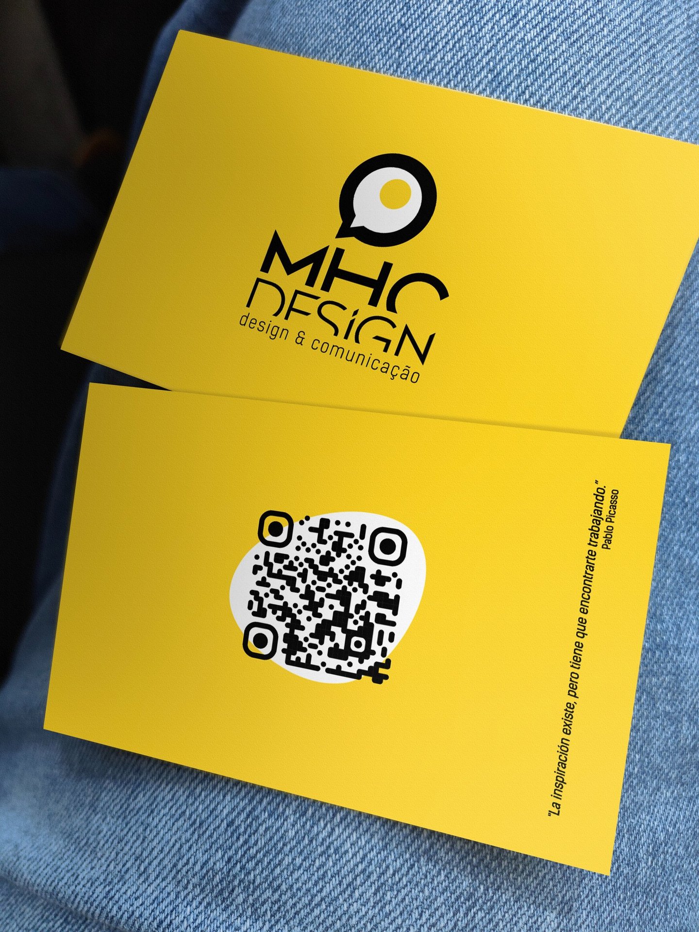 a person holding a qr code on a yellow business card