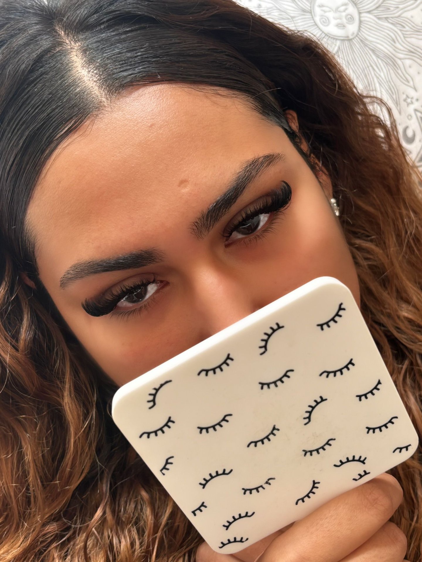 alt="mobile lash technician applying lashes in London home"