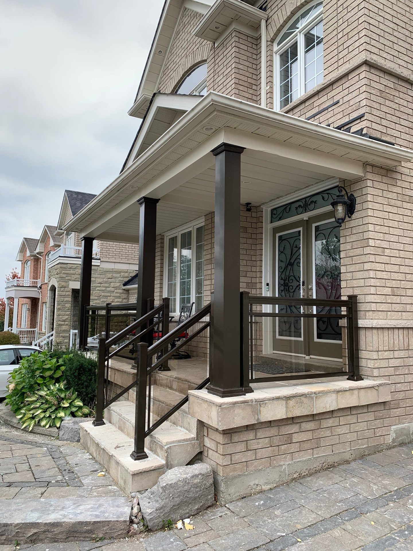  front porch with brown collumns improve the look of the house