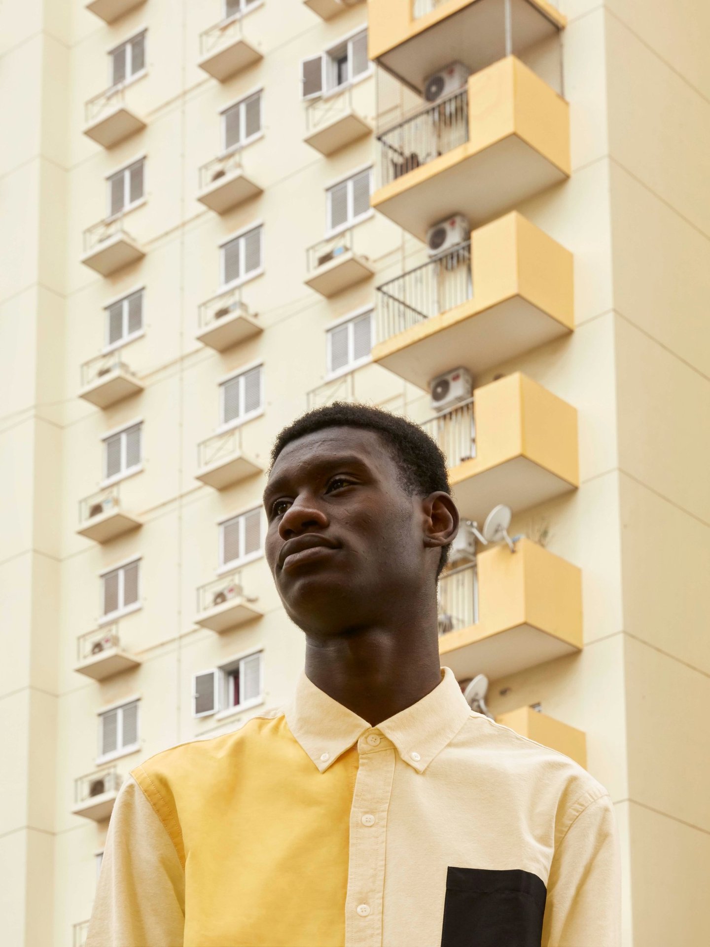 a man in a yellow shirt and black pants